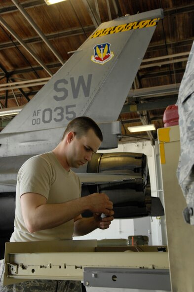 Airman Matthew Delpit, a member of the 79th Air Maintenance Unit, checks off his work station during the Weapons Load Crew of the Quarter Competition at Shaw AFB, S.C., April 10, 2009. Load crews are evaluated on safety and reliability as well as a toolbox inspection and written exam.  (U.S. Air Force photo by Senior Airman Kathrine McDowell/Released)