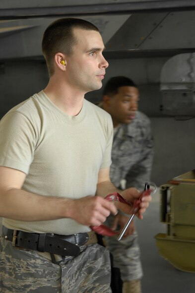 Airman Matthew Delpit, left, a member of the 79th Air Maintenance Unit, is followed by his evaluator, Staff Sgt. Delmont Benjamin, as he participates in the Weapons Load Crew of the Quarter Competition at Shaw AFB, S.C., April 10, 2009. Load crews are evaluated on safety and reliability as well as a toolbox inspection and written test.  (U.S. Air Force photo by Senior Airman Kathrine McDowell/Released)
