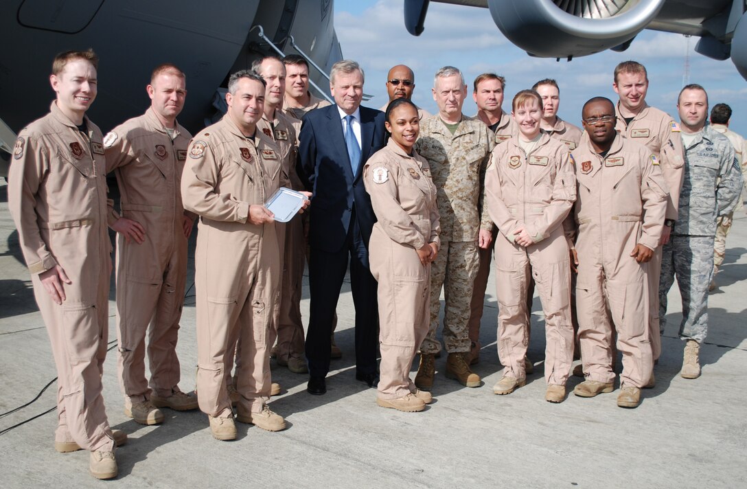 Reservists from the 315th Airlift Wing, Charleston Air Force Base S.C., stand in Brussels, Belgium with NATO Secretary General Jaap de Hoop Scheffer and Commander United States Joint Forces Command, General James Mattis who also serves as NATO Supreme Allied Commander for Transformation, as they are presented with a silver NATO platter upon returning from a successful mission to Baghdad, Iraq. (U.S. Air Force photo/Major Bill Walsh) 