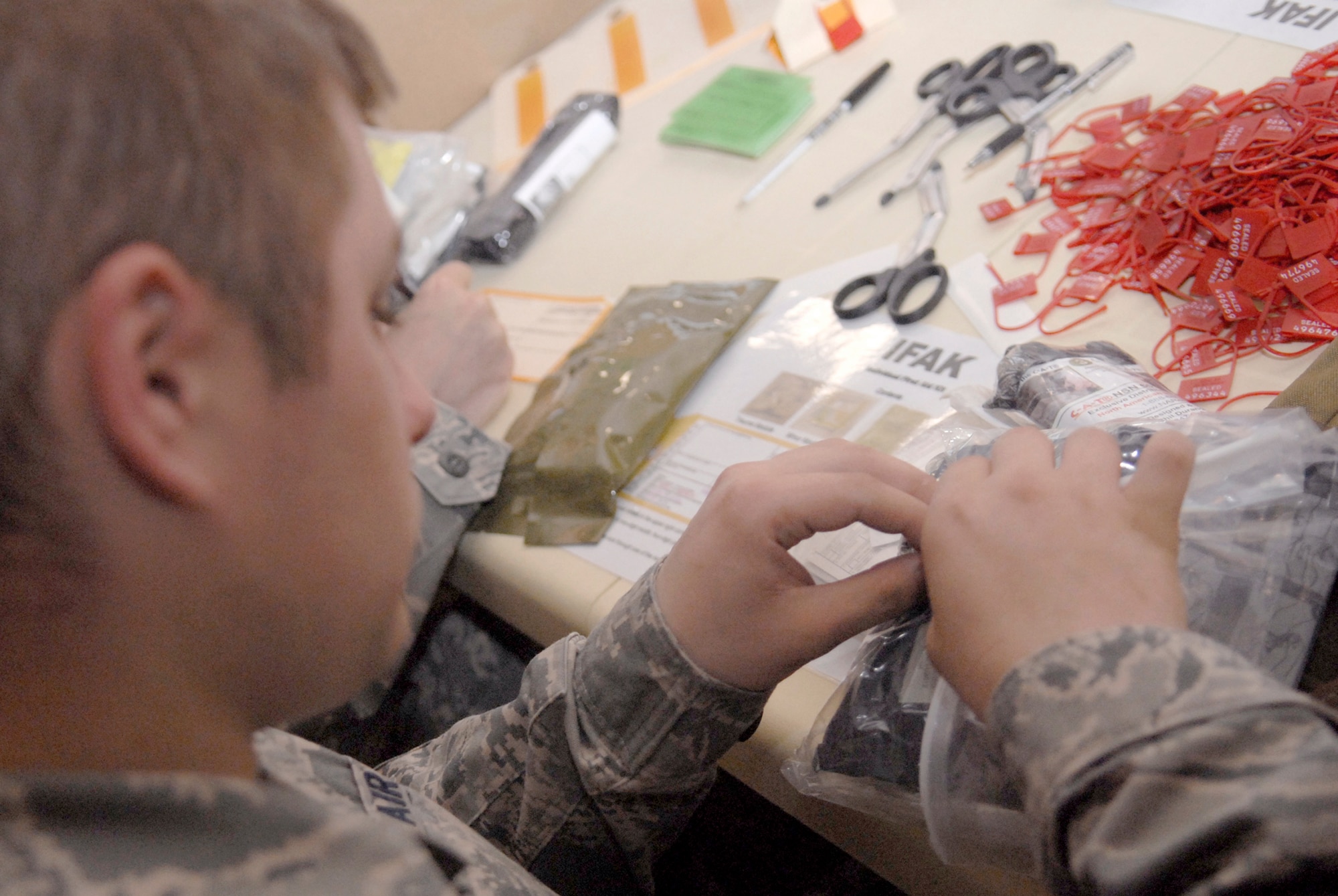 Senior Airman Jonathan Bose assembles individual first aid kits April 9 at an air base in Southwest Asia. The individual first aid kits are given to Airmen who are going to locations throughout the U.S. Central Command's area of responsibility. Airman Bose is assigned to the from the 379th Expeditionary Communications Squadron and volunteered to assemble individual first aid kits. He hails from Terre Haute, Ind., and is deployed from 181st Intelligence Air National Guard Wing Hulman Field, Ind. (U.S. Air Force photo/Senior Airman Andrew Satran) 
