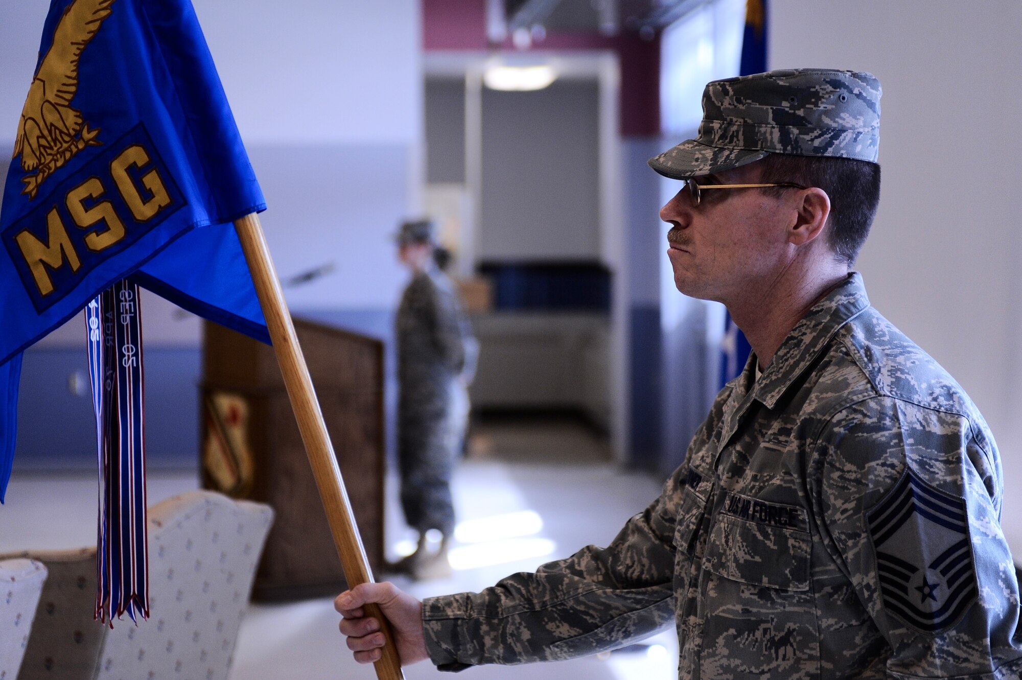 Chief Master Sgt. Richard Womer, 354th Mission Support Group superintendent, holds the guidon prior to the 354th Mission Support Group assumption of command ceremony April 7, 2009, Eielson Air Force Base, Alaska. The guidon symbolizes the relinquishment of authority from the outgoing commander to the incoming commander.  (U.S. Air Force photo/Senior Airman Jonathan Snyder)