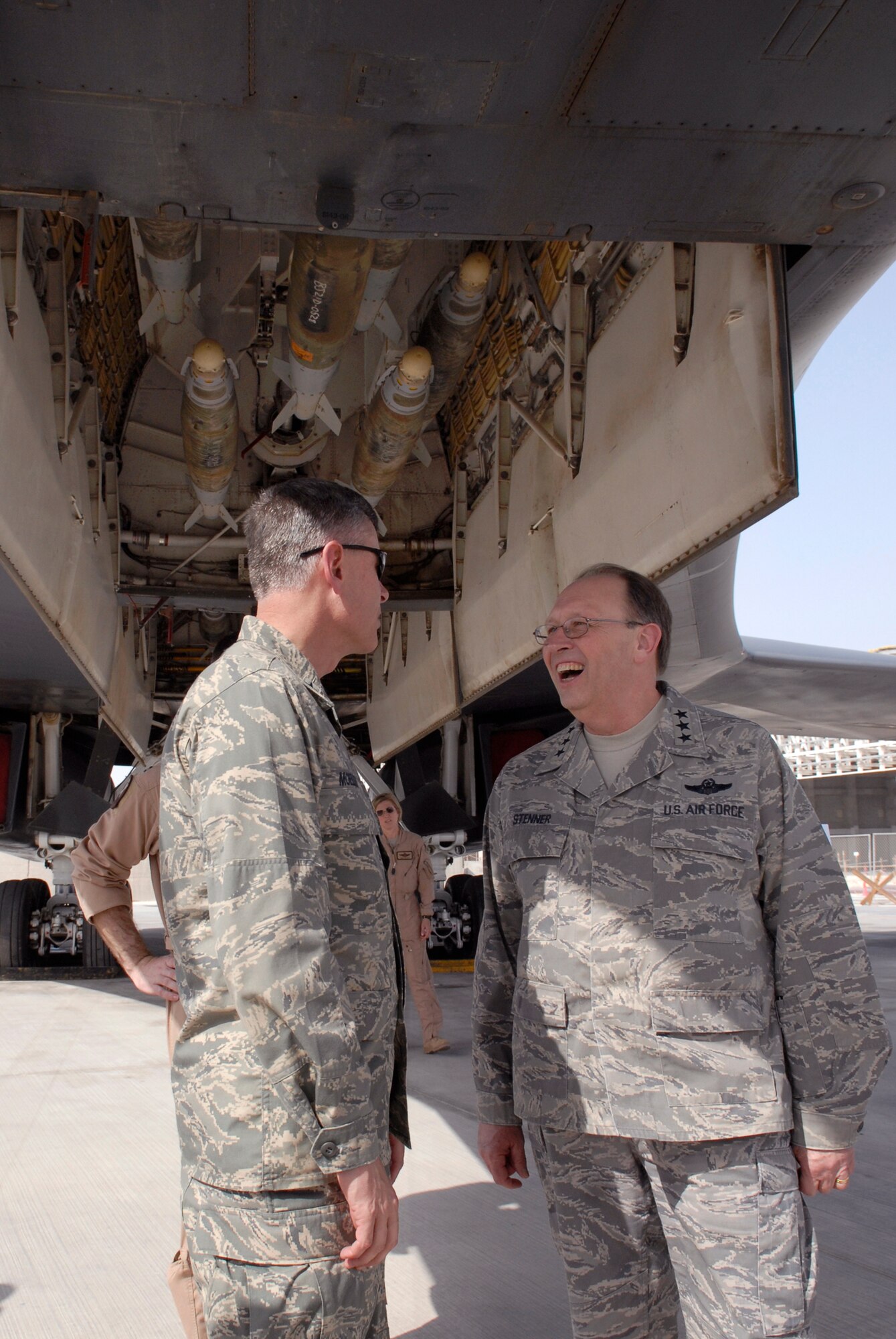 Brig. Gen. Michael Moeller (left), commander of the 379th Air Expeditionary Wing, speaks with Lt. Gen. Charles Stenner April 6 while looking over the business end of a B-1B Lancer at an air base in Southwest Asia. General Stenner is commander of Air Force Reserve Command and chief of the Air Force Reserve.  He visited many areas of the base and numerous Reserve Airmen who are deployed here. (U.S. Air Force photo/Senior Airman Andrew Satran)