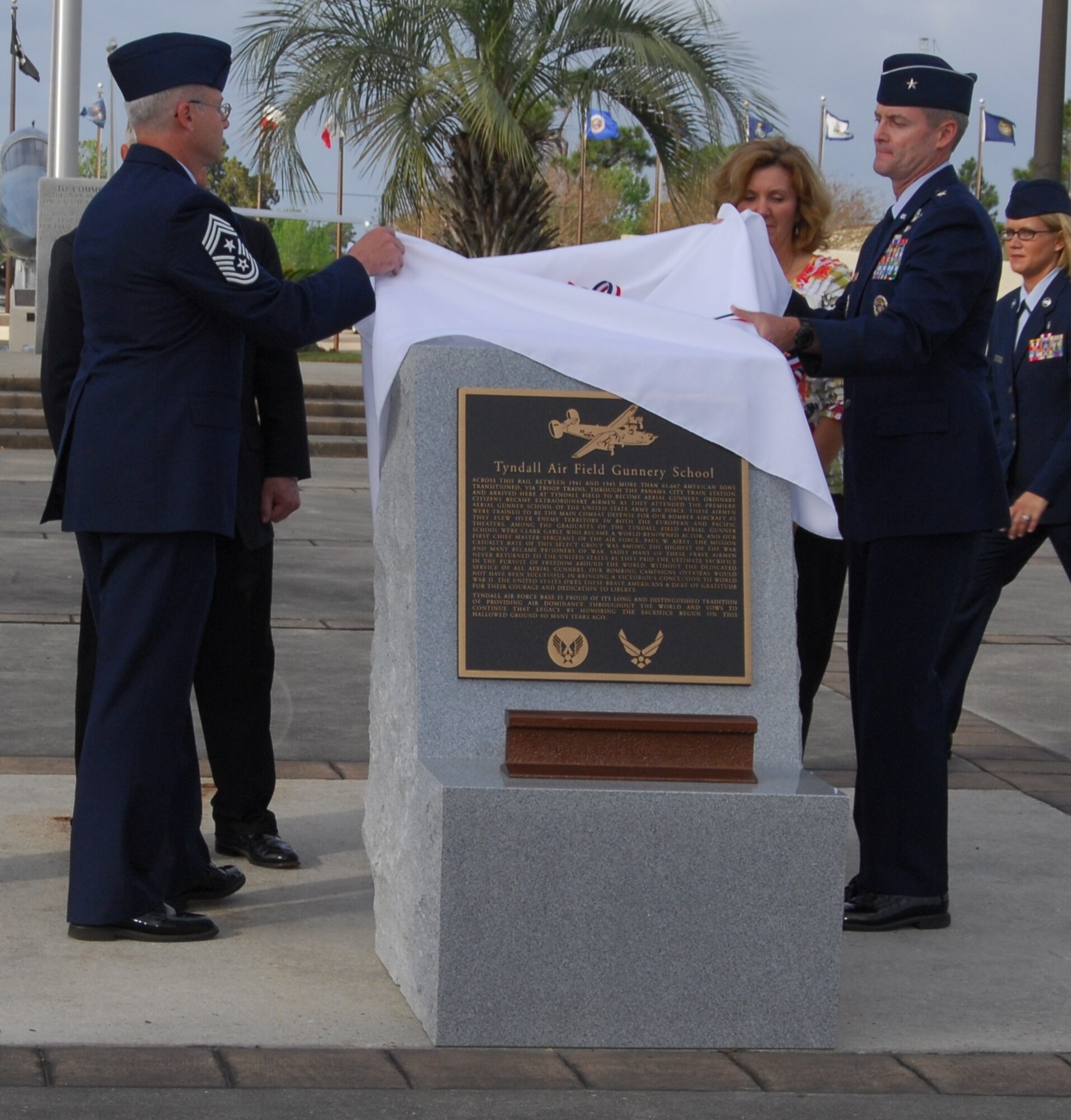 Command Chief Master Sgt. Benjamin Van Vleet, 325th Fighter Wing command chief and Brig. Gen. Darryl Roberson, 325th FW commander, reveal the Aerial Gunnery School monument during a dedication ceremony to honor the monument April 10, at Maxwell Flag Park.  (U.S. Air Force photo by Lisa Norman)