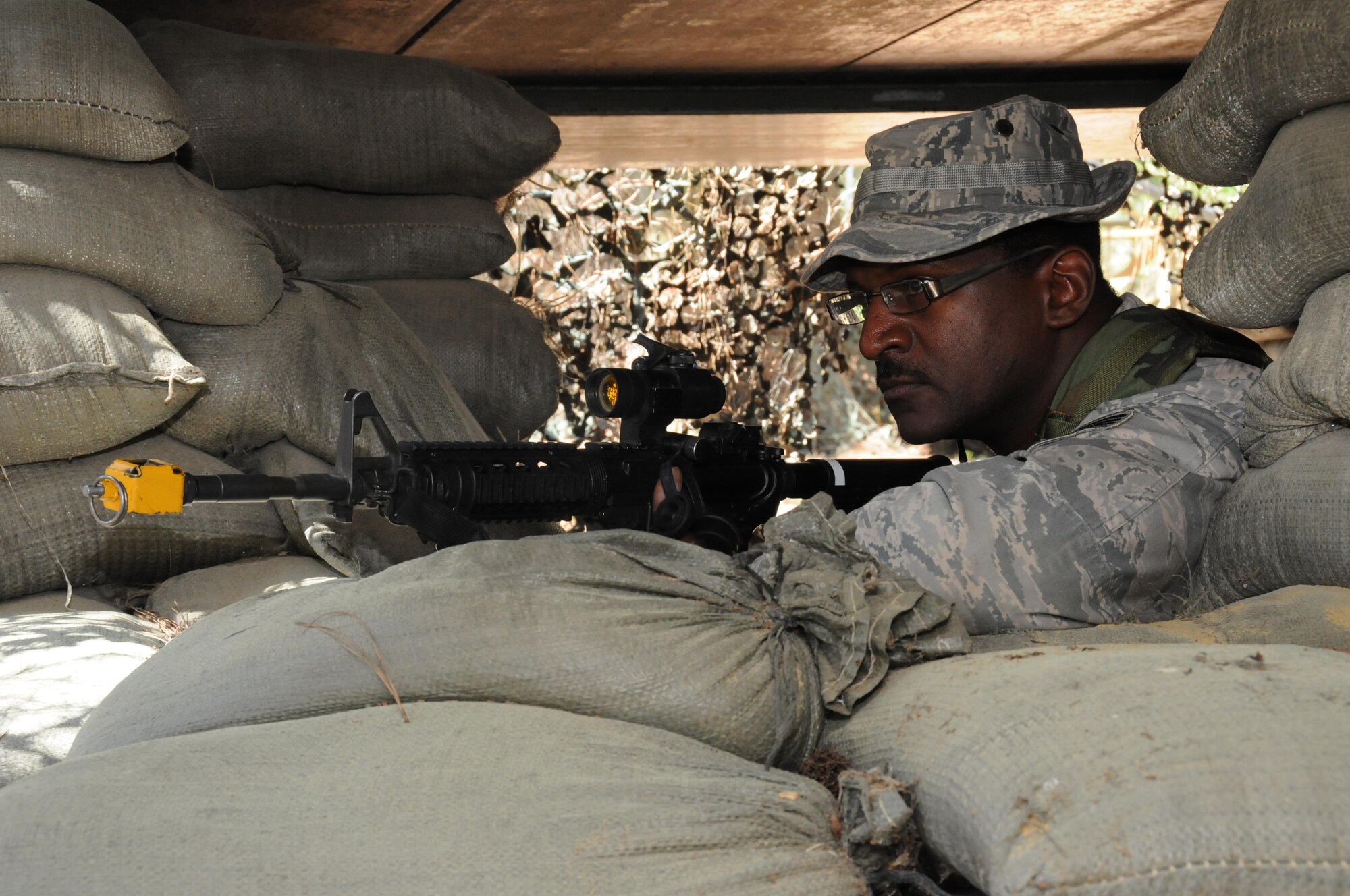 SEYMOUR JOHNSON AIR FORCE BASE, N.C. -- Staff Sgt. Stephen Jones, a Reservist with the 916th Security Forces Squadron, takes aim from a defensive posture bunker during a recent air base defense exercise held during the unit training assembly weekend. (U.S. Air Force photo by: Tech. Sgt. Scotty Sweatt)