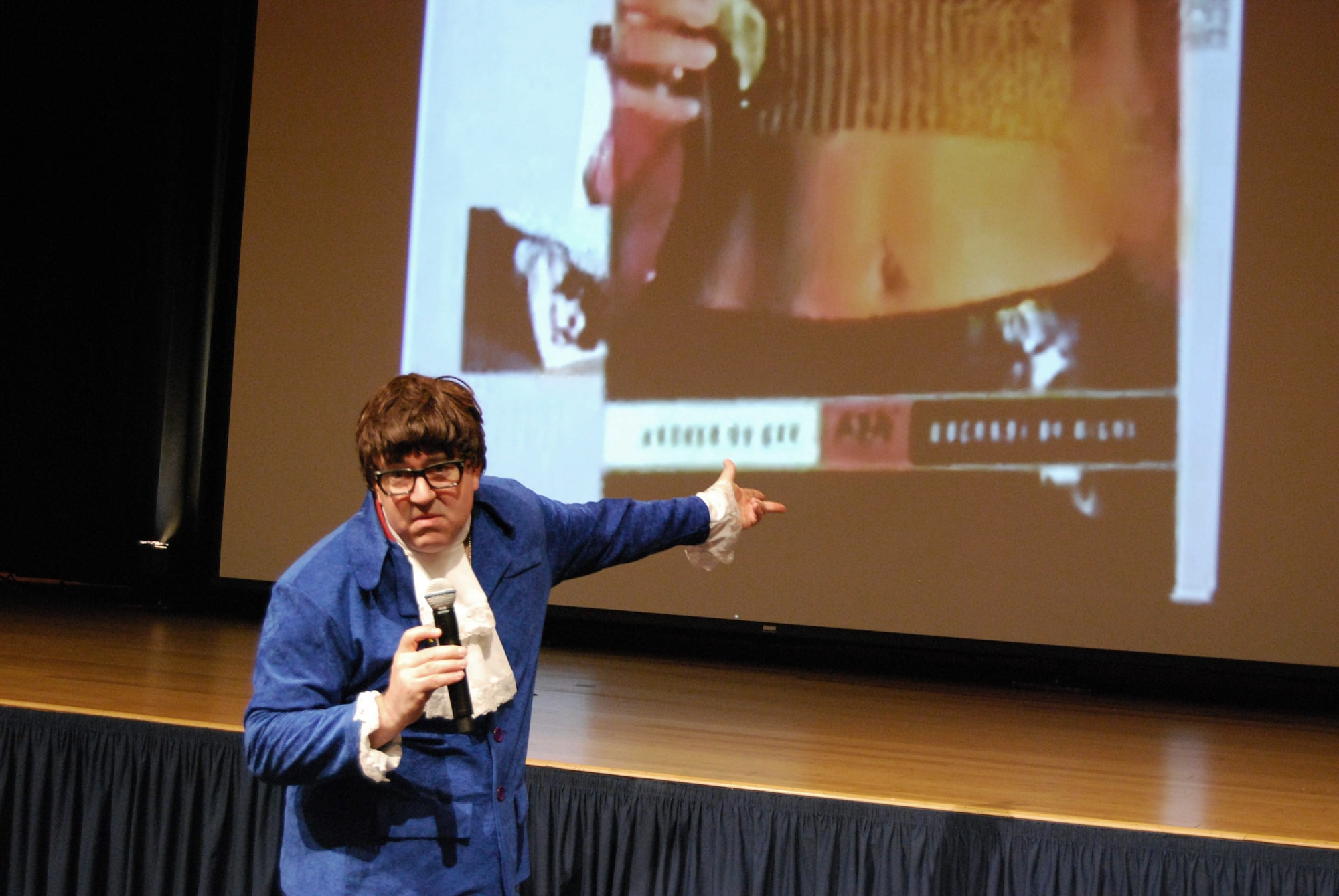 Sexual assault awareness activist Ben Atherton-Zeman impersonates Austin Powers in his one-man show "Voices of Men" April 9 at the Pentagon Auditorium in Arlington, Va. The innovative one-man play blends multimedia, humor and celebrity voice impressions to educate military and civilian members about sexual assault and other forms of violence. (U.S. Air Force photo/Tech. Sgt. Amaani Lyle)
