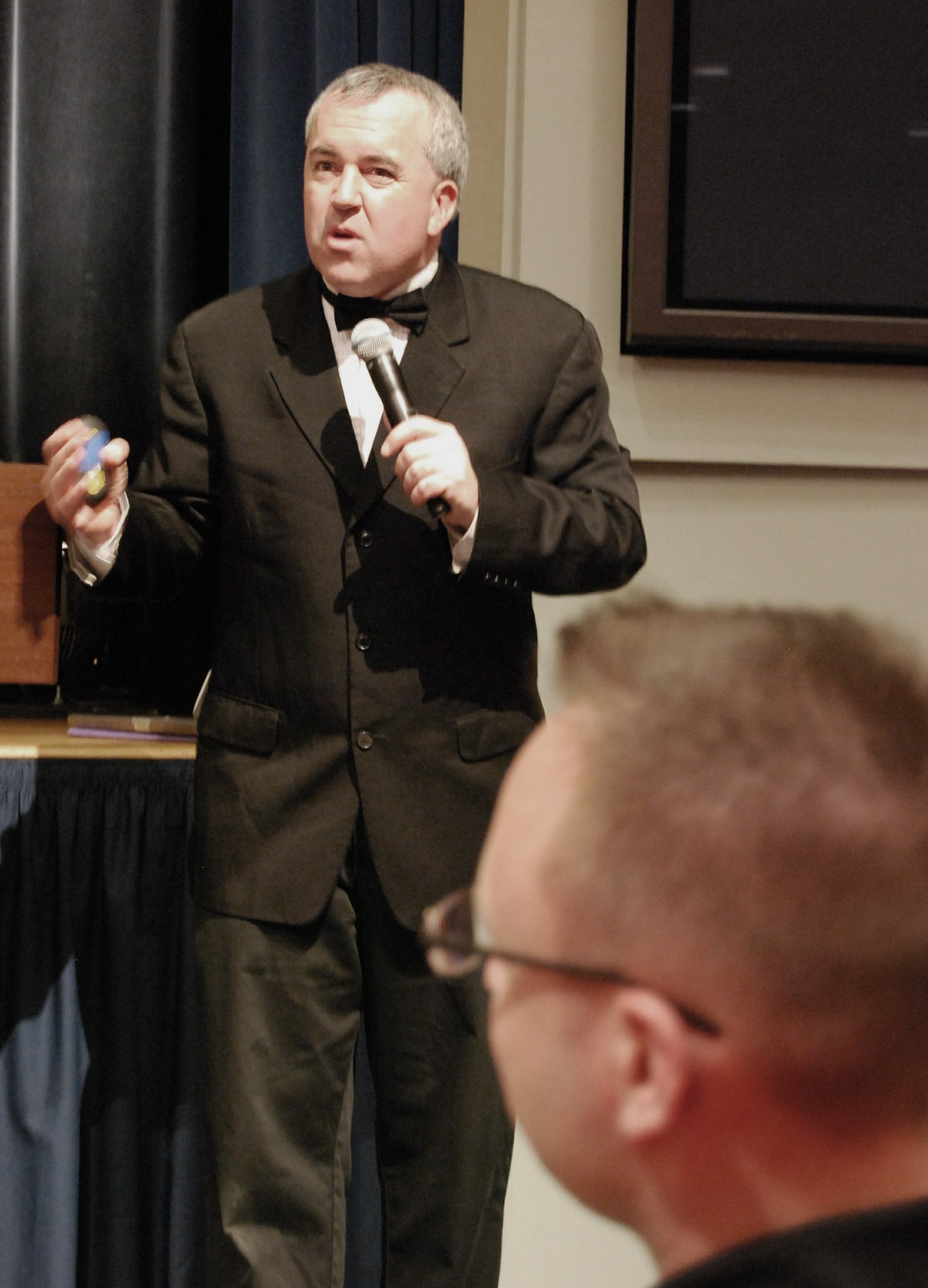 Sexual assault awareness activist Ben Atherton-Zeman impersonates James Bond in his one-man show "Voices of Men" April 9 at the Pentagon Auditorium in Arlington, Va. The innovative one-man play blends multimedia, humor and celebrity voice impressions to educate military and civilian members about sexual assault and other forms of violence. (U.S. Air Force photo/Tech. Sgt. Amaani Lyle)