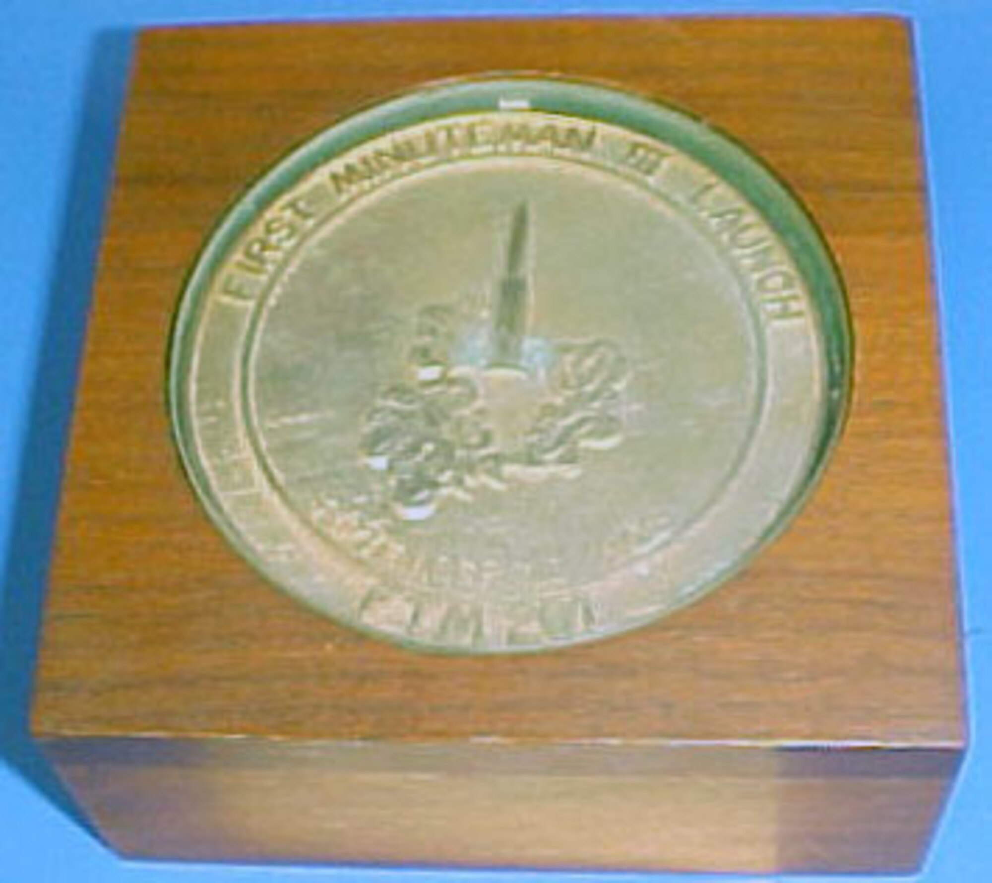 This commemorative coin shows an image of a rocket launch and says "First Minuteman III Launch, September 16, 1968, FTM 201." (U.S. Air Force photo)