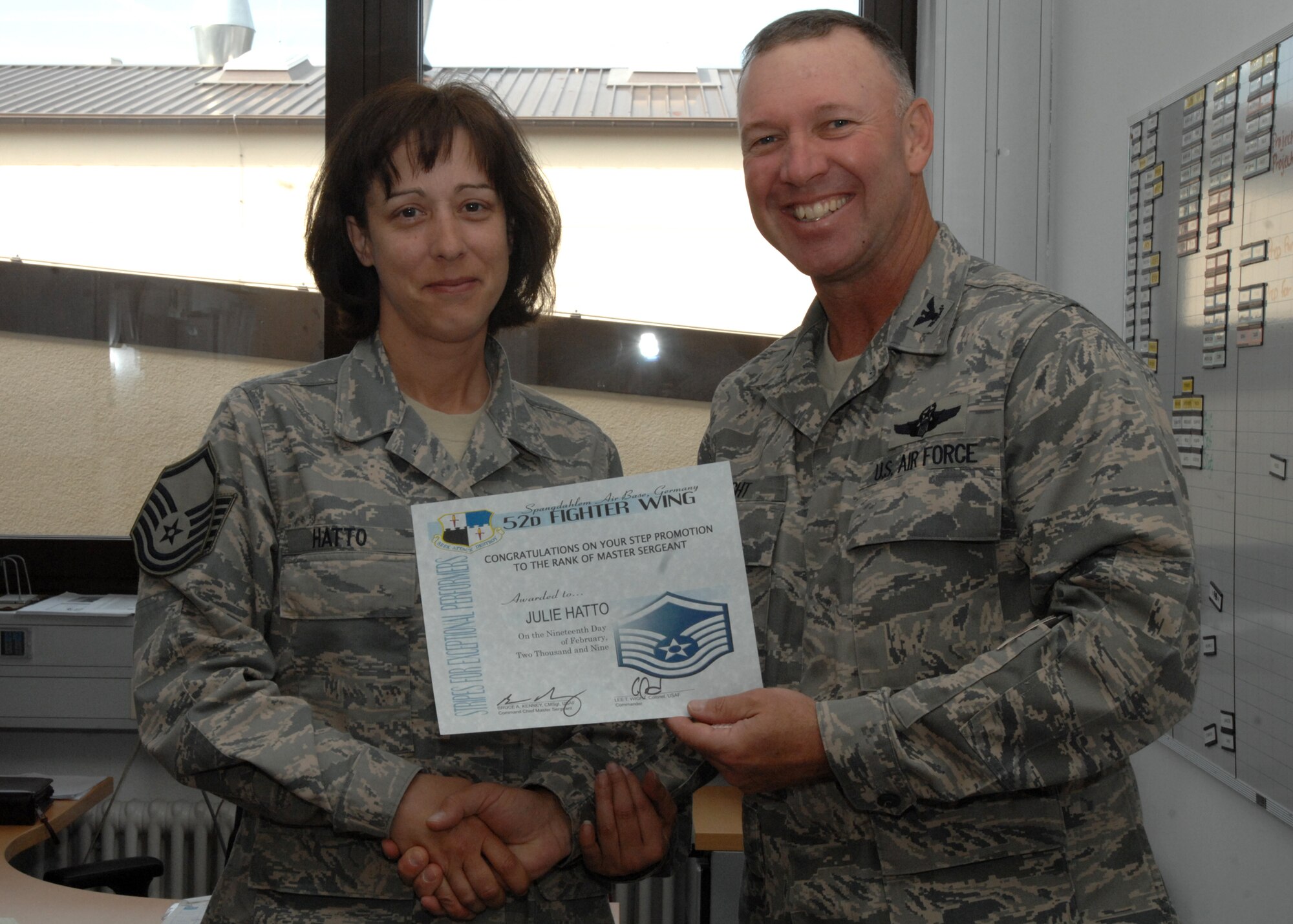 SPANGDAHLEM AIR BASE, Germany -- Master Sgt. Julie Hatto, 606th Air Control Squadron assistant noncommissioned officer in charge of Satellite Communications, is congratulated by Col. Lee T. Wight, 52nd Fighter Wing commander, for earning a Stripes for Exceptional Performers promotion to Master Sgt. April. 7, 2009. Each year a limited number of Airmen receive a STEP promotion for continually doing outstanding work. (U.S. Air Force photo by Senior Airman Jenifer H. Calhoun)