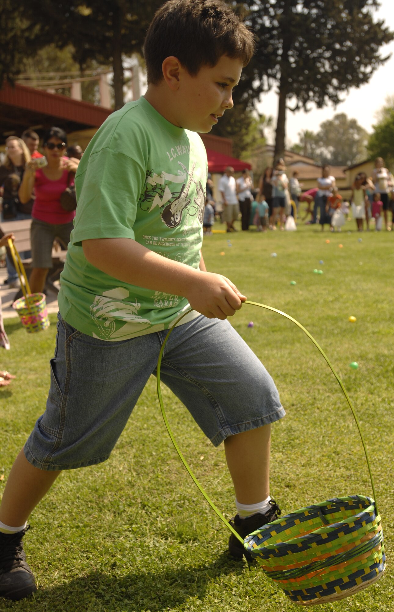 Jon Shick, son of David Shick, base contractor, runs into a field of eggs during the annual spring egg hunt, Saturday, April 11, 2009 at Arkadas Park. Approximately 550 base residents participated in activities at the event, which included arts and crafts, photos with the Easter Bunny and egg hunts. Four different age groups participated in the egg hunts, which included 18 golden eggs. Golden eggs were turned in after the hunt for an Easter basket or a prize. (U.S. Air Force photo/Senior Airman Benjamin Wilson)