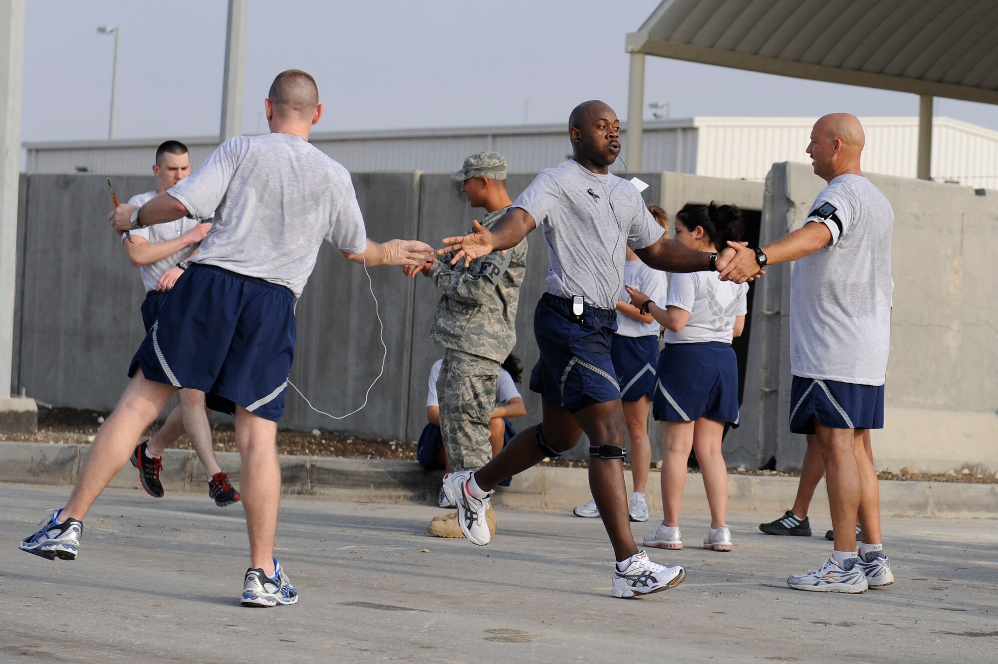 Tech Sgt. Tony Waddell, 380th Expeditionary Communications Squadron, receives congratulations as he finishes a 10k run at an undisclosed location in Southwest Asia, April 8. The 10k was part of a 1 mile walk and 5k/10k fun run for Sexual Assault Awareness Month. Sergeant Waddell is deployed from RAF Lakenheath, England and hails from Rockingham, N.C. (U.S. Air Force photo by Senior Airman Brian J. Ellis) (Released)
