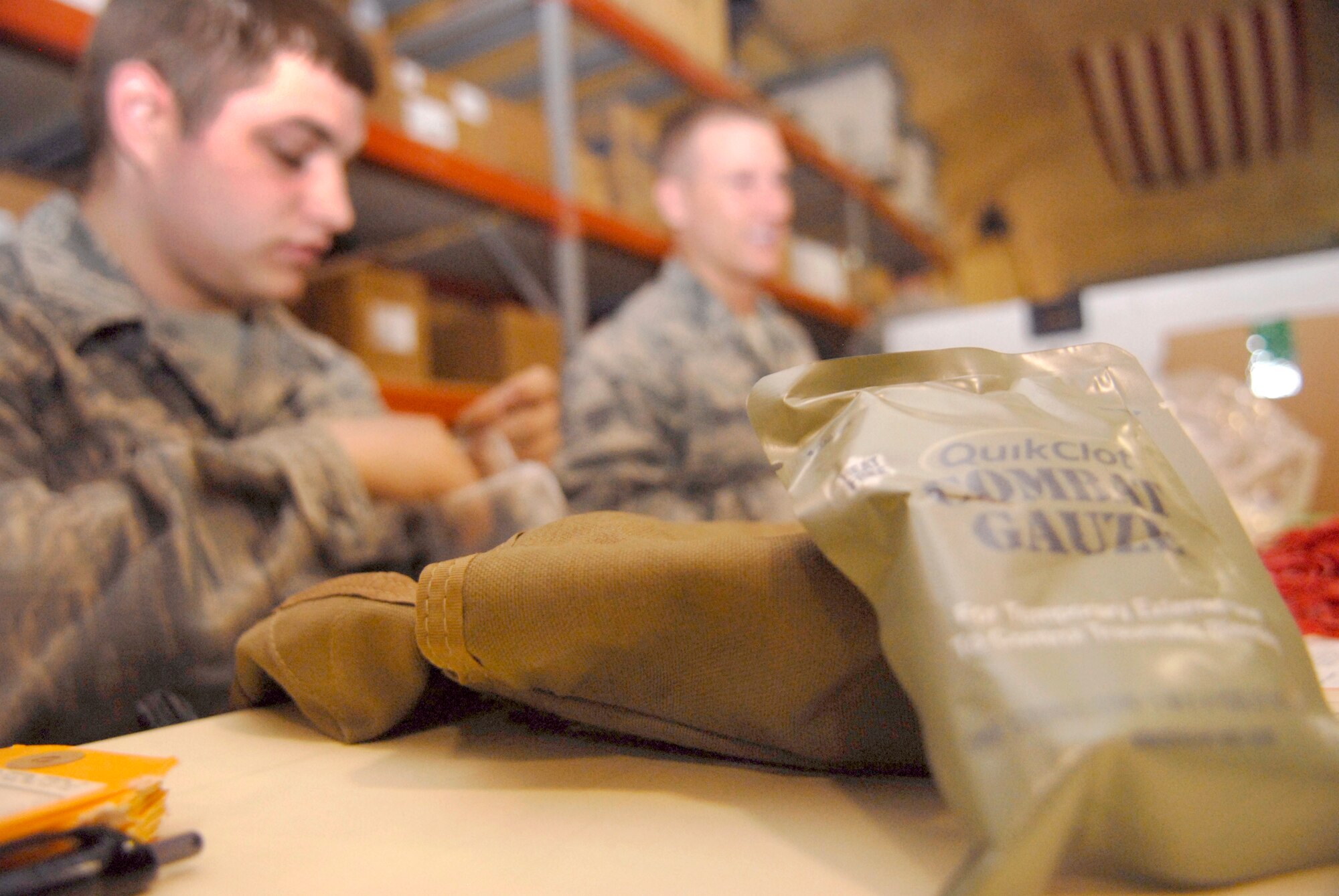 Airmen from different organizations all over the 379th Air Expeditionary Wing, volunteer to assemble Individual First Aid Kits (IFAK) for distribution to personnel down range, Apr. 9 2009, at an undisclosed base in Southwest Asia.  The IFAKs contain Quik Clot combat gauze, among other first aid items and are contained in a canvas carry pouch.  The Airmen work on the IFAK program in support of Operation Iraqi and Enduring Freedom and Combined Joint Task Force - Horn of Africa.  (U.S. Air Force photo/Senior Airman Andrew Satran/released)