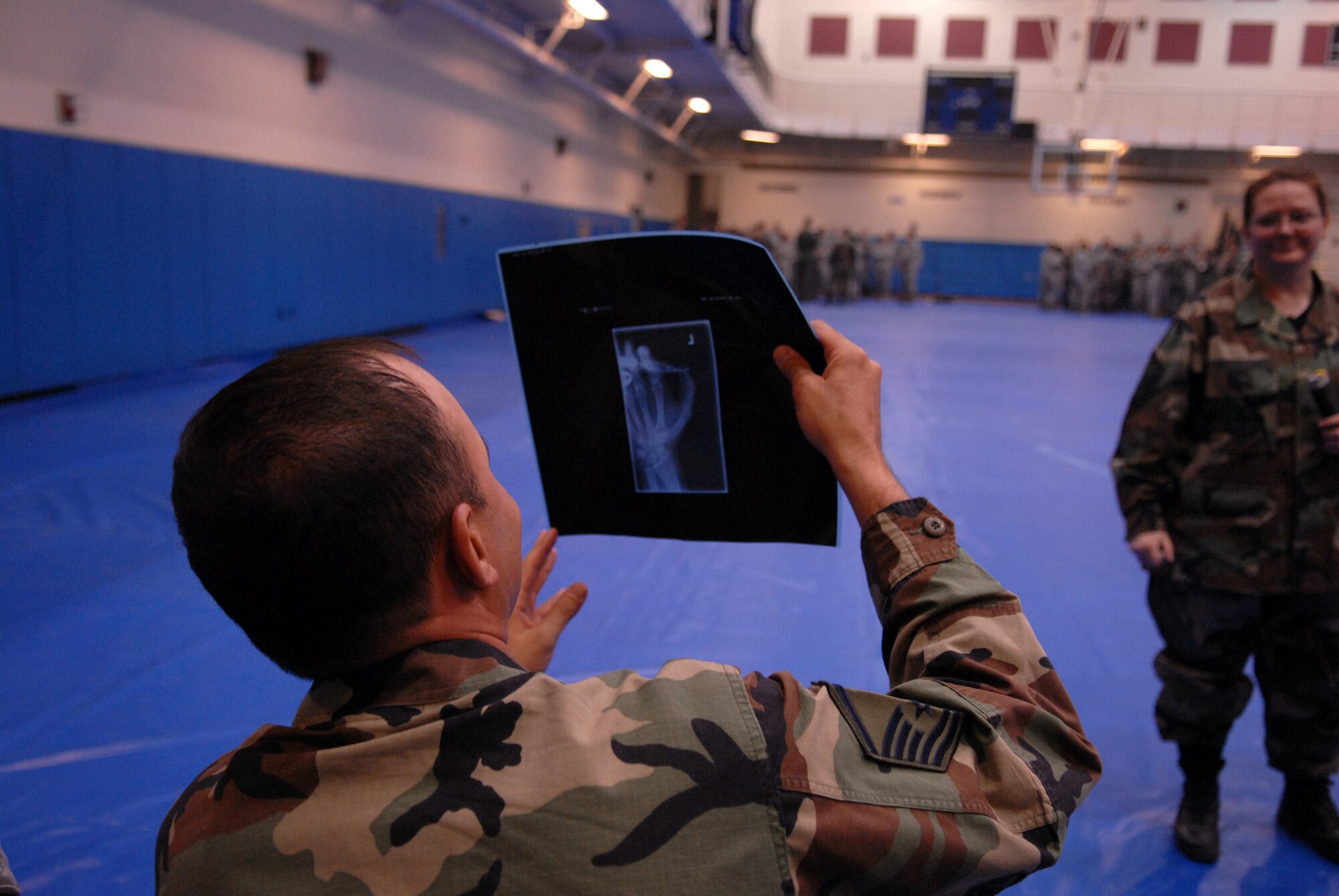 Master Sgt. Wilson Santiago, 8th Communications Squadron, looks at an X-ray of a person's hand accidentally punctured by a nerve agent antidote injector, during Wolf War Day at Kunsan Air Base, Republic of Korea, April 13, 2009. Wolf War Day was a base-wide refresher for Self Aid and Buddy Care, and Ability To Survive and Operate in preparation for the upcoming Operational Readiness Inspection.  