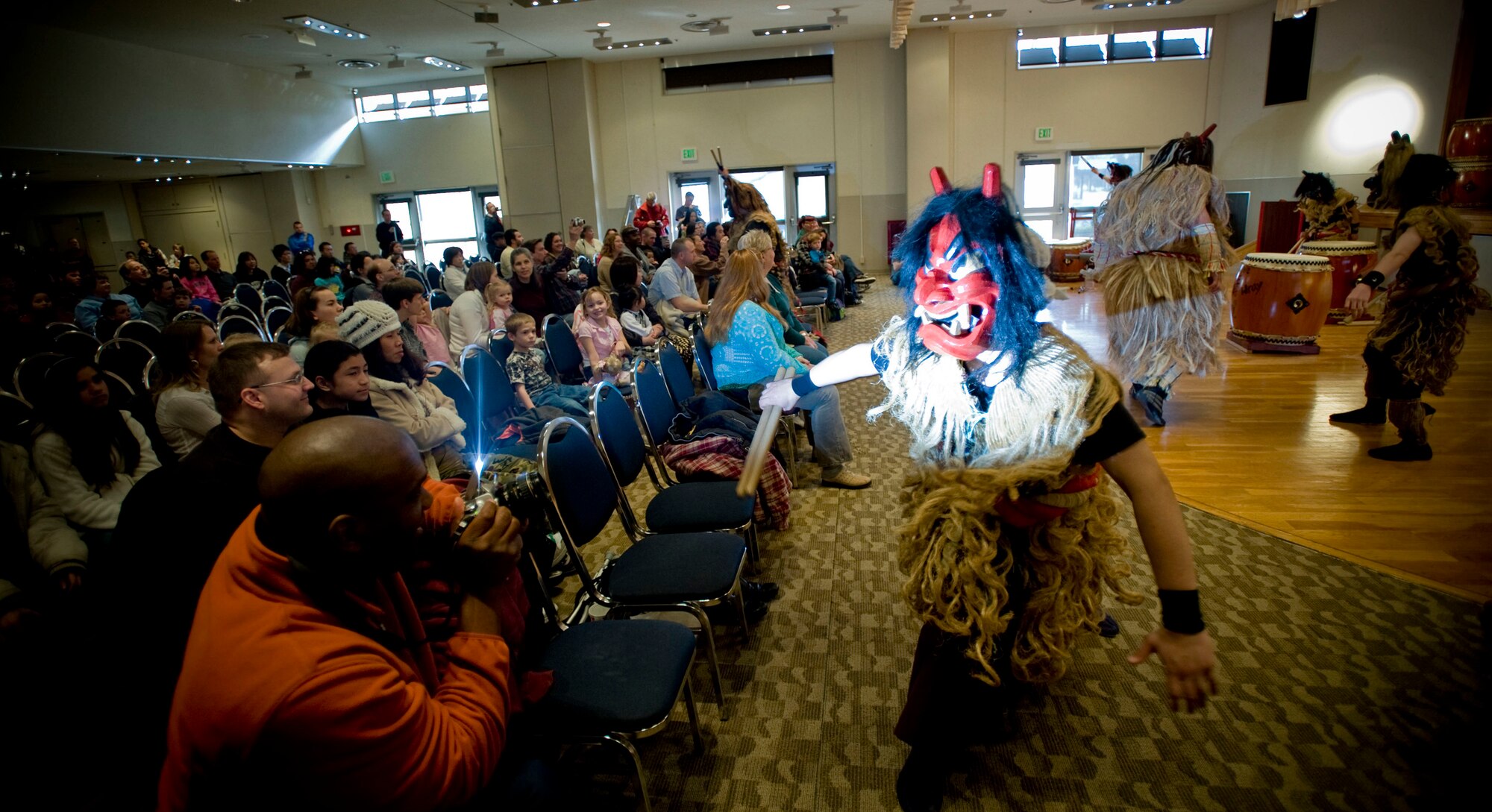 MISAWA AIR BASE, Japan -- A spectator takes a photo of an American taiko player dressed as a namahage at the Mokuteki Community Center March 28, 2009. In Japanese legend, the namahage are the incarnation of the mountain god, punishing the lazy and bringing good luck to the productive. (U.S. Air Force photo by Staff Sgt. Samuel Morse)