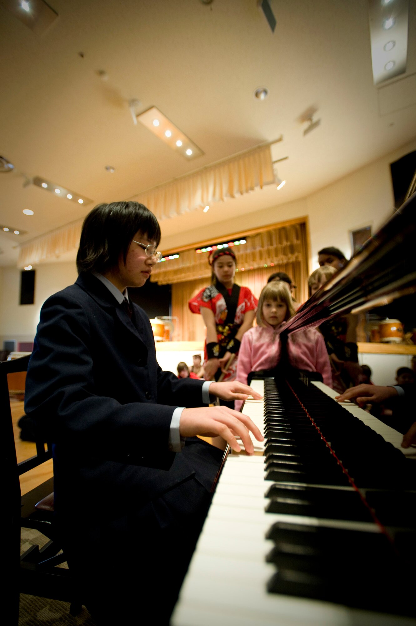 MISAWA AIR BASE, Japan -- Yurie Kubo, niece of Dragon-Eagle Taiko instructor Kazuko Igarashi, plays a piano solo during the taiko team's intermission March 28, 2009. For the first time, Ms. Igarashi's niece and son performed in the concert. (U.S. Air Force photo by Staff Sgt. Samuel Morse)