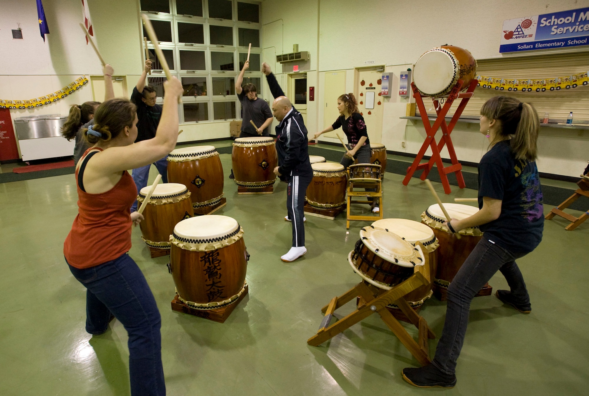 MISAWA AIR BASE, Japan -- Kiyotaka Hosoi (center), master taiko teacher, instructs the advanced group of the Dragon-Eagle Taiko team Feb. 27, 2009. Mr. Hosoi visits the group monthly to provide additional training to improve their playing. (U.S. Air Force photo by Staff Sgt. Samuel Morse)