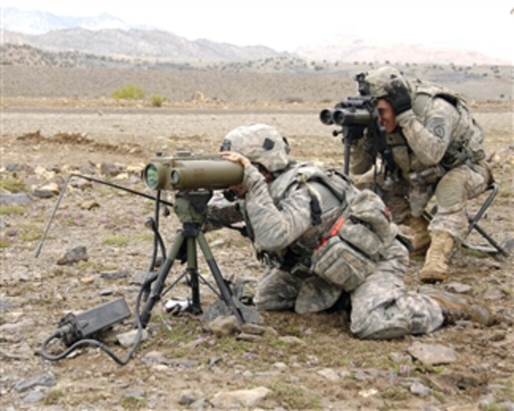 U.S. Army soldiers from the 1st Battalion, 501st Infantry Regiment observe the impacts of artillery fire to calibrate for accuracy near Camp Clark in Afghanistan on April 7, 2009.  