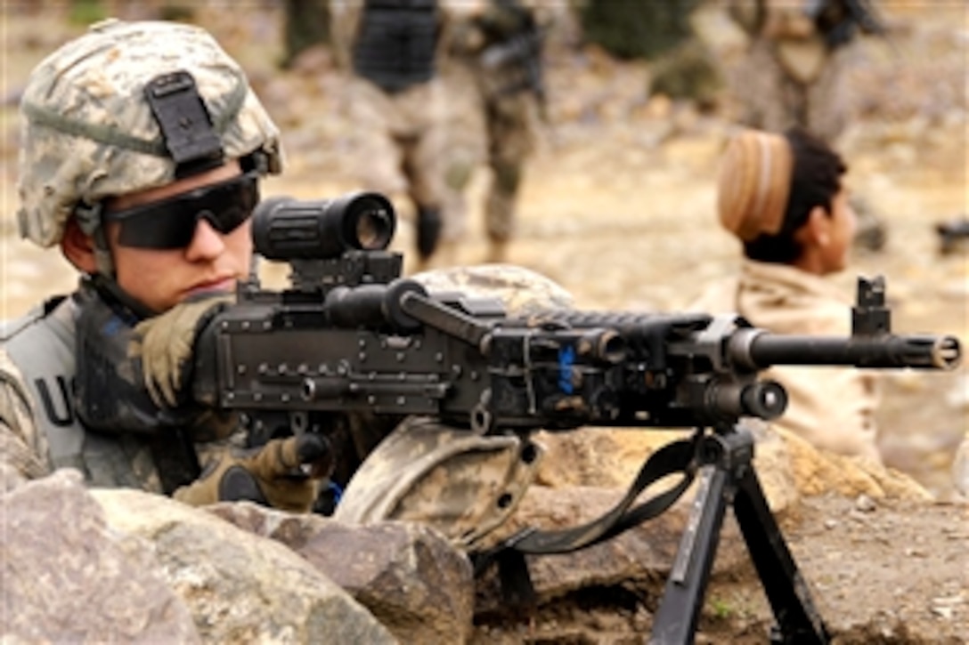 A U.S. Army soldier looks though the scope on his M-60 machine gun while providing security during a key leader engagement at Shabow-Kheyl, Afghanistan, April 8, 2009. The soldier is assigned to Company D, 1st Battalion, 501st Parachute Infantry Regiment.