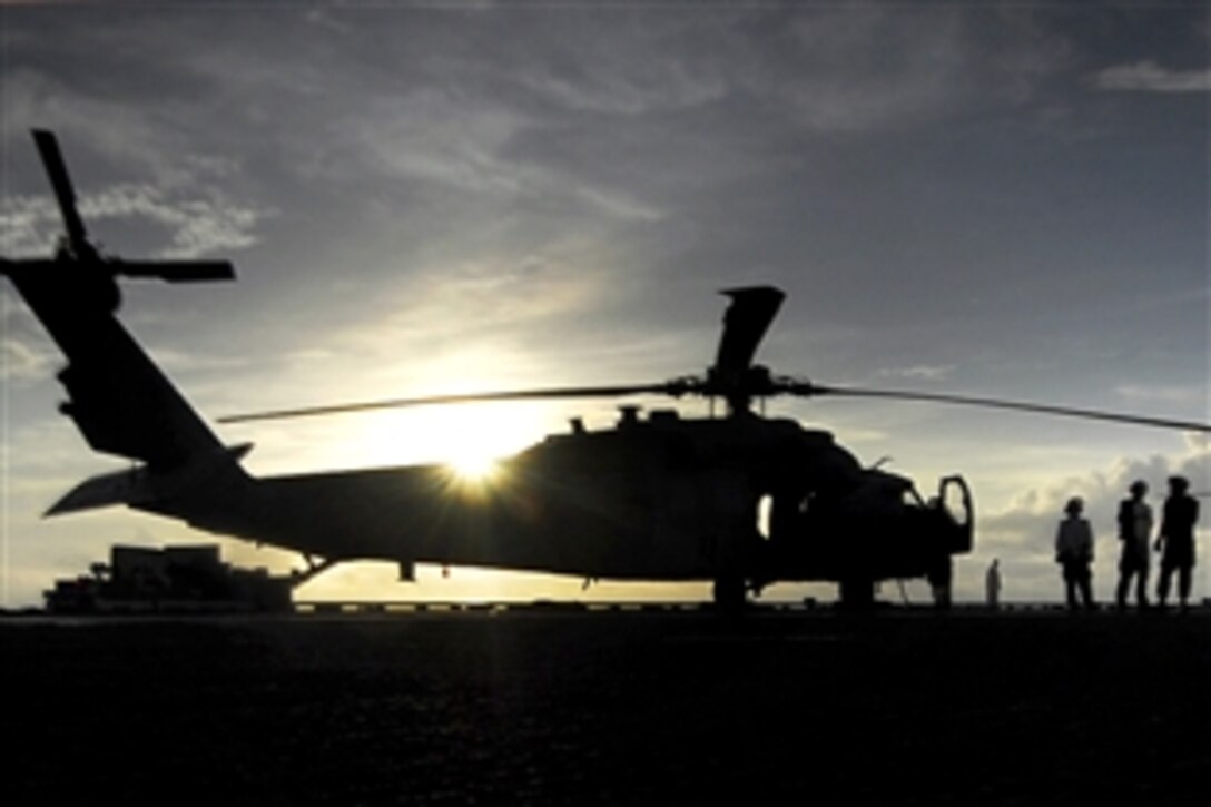 U.S. Navy sailors on flight deck of the aircraft carrier USS John C. Stennis prepare two MH-60S Sea Hawk helicopters for flight operations in the Pacific Ocean, April 7, 2009. Stennis is on a scheduled six-month deployment to the western Pacific Ocean.