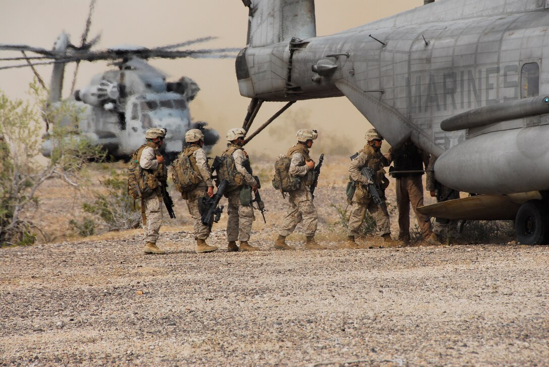 Marines with 3rd Battalion, 9th Marine Regiment, board a CH-53E Super Stallion after securing a landing zone on an Army Yuma Proving Ground range in Yuma, Ariz., as part of a Weapons and Tactics Instructor course April 13, 2009. The battalion is training for its deployment in August 2009. The Camp Lejeune, N.C., battalion is scheduled to conclude their training in Yuma with a battalion-sized helicopter-borne assault exercise in late April, the largest exercise of its type conducted in approximately 10 years.