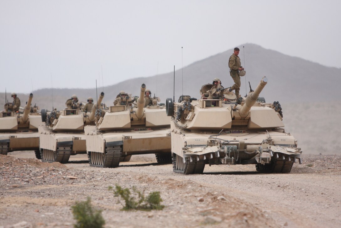 Marines and sailors of first platoon, Company C, 1st Tank Battalion, return to their command post after undergoing a five-day, annual life-fire training exercise at Noble Pass April 14.