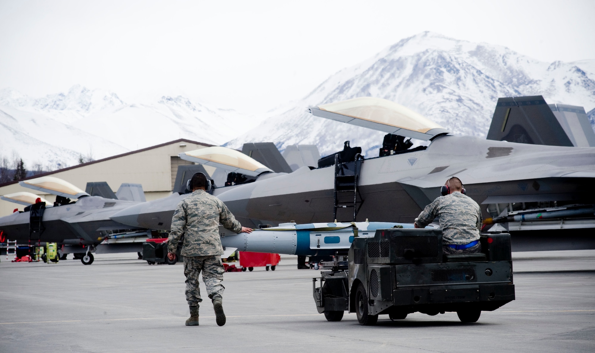ELMENDORF AIR FORCE BASE, Alaska-- Staff Sgt. Michael Kalmar and Staff Sgt. Justin Akins moves a Joint Direct Attack Munition (JDAM) down the flight line April 14, 2009. Kalmar and Akins are from the 525th Aircraft Maintenance Unit ensure that the first JDAM dropped by 525th Fighter Squadron is successful. (U.S. Air Force photo by Senior Airman Jonathan Steffen)