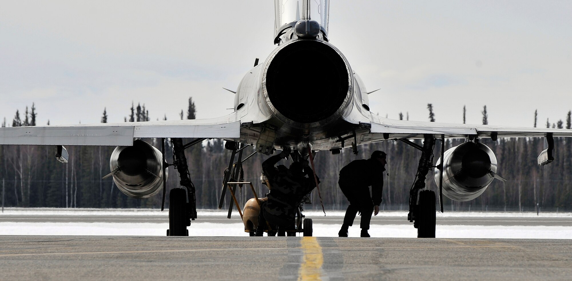 Aircraft maintainers from Luxeuil Air Base, France conduct post flight checks April 14, 2009, Eielson Air Force Base, Alaska. The French Air Force brought two variations of the Mirage 2000 Fighter with them to participate in Red Flag-Alaska 09-2. This exercise provides joint offensive counter-air, interdiction, close air support, and large force employment training in a simulated combat environment. (U.S. Air Force photo/Airman 1st Class Willard E. Grande II)