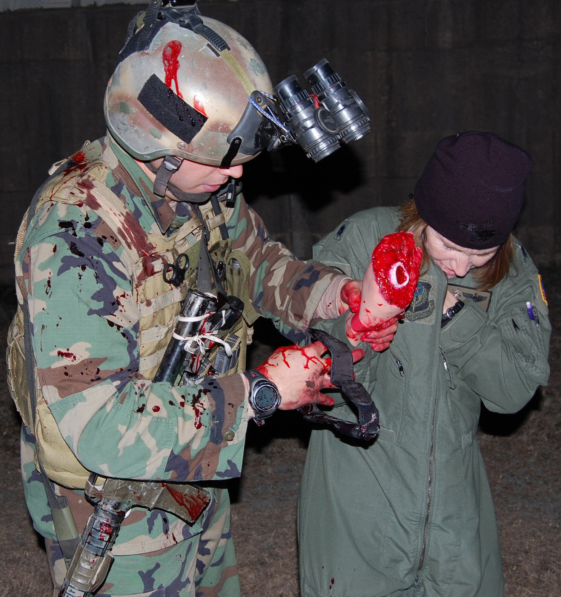 DAEGU AIR BASE, Republic of Korea -- A pararescueman from the 320th Special Tactics Squadron prepares to put a tourniquet on Lt. Col. Leslie Babich, 353rd Operations Support Squadron, to stop the bleeding from a simulated wound during a mass casualty exercise here April 1. More than 350 members and several aircraft assigned to the 353rd Special Operations Group spent nearly a month at Daegu Air Base, Republic of Korea, testing and assessing their wartime skills necessary to survive and operate in any environment. (U.S. Air Force photo by James D'Angina)