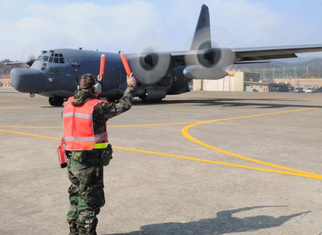 DAEGU AIR BASE, Republic of Korea -- A maintainer from the 353rd Maintenance Squadron marshals a 1st Special Operations Squadron MC-130H Combat Talon II before take-off here March 24. More than 350 members and several aircraft assigned to the 353rd Special Operations Group spent nearly a month at Daegu Air Base, Republic of Korea, testing and assessing their wartime skills necessary to survive and operate in any environment. (U.S. Air Force photo by Tech. Sgt. Aaron Cram)