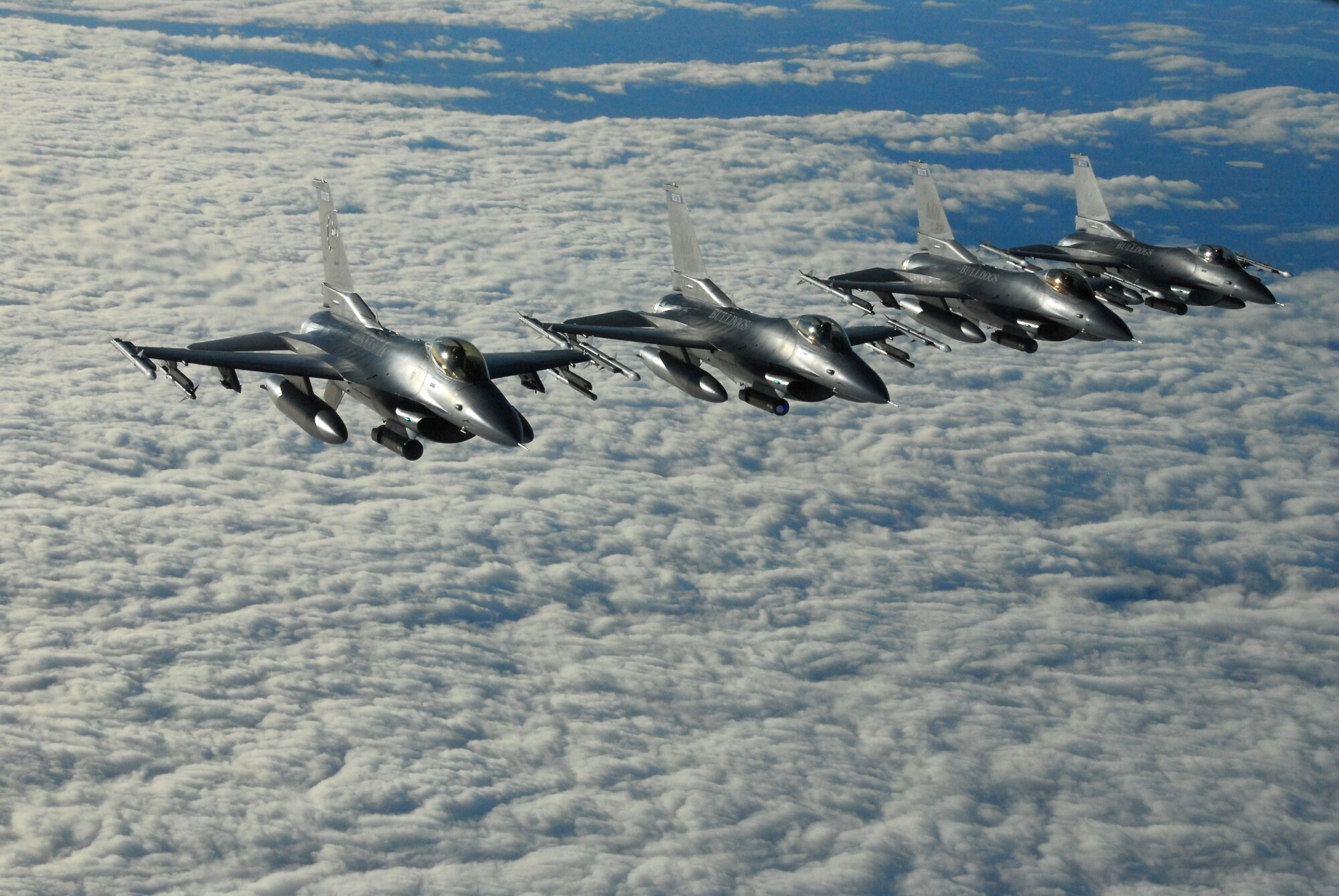A four ship F-16 Fighting Falcon formation flies through the sky on a mission in northern Minnesota on Nov. 17, 2007.  The F-16's, from the 148th Fighter Wing of the Minnesota Air National Guard in Duluth, were practicing mid-air refueling from a KC-135 Stratotanker in order to fulfill training requirements.  (U.S. Air Force photo by Tech. Sgt. Brett R. Ewald)  (Released)