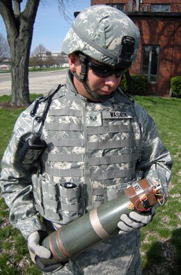 Staff Sgt. Gabriel Wasnuk, an explosive ordnance disposal team leader with the 88th Air Base Wing at Wright-Patterson Air Force Base, Ohio, demonstrates a simulated improvised explosive device or IED. Base EOD specialists credit their proficiency training to helping save the lives of U.S. and coalition joint servicemembers in Iraq and Afghanistan. (U.S. Air Force photo/Derek Kaufman)