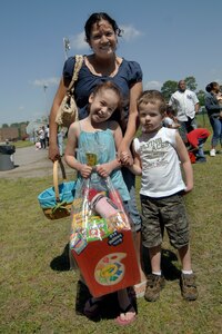 Haley Munton poses with mother, Deliah and brother, Michael, after receiving a prize for finding a special egg during the Easter egg hunt at Youth Programs April 11. An assorted Easter basket was given to the child who found the prize egg in each age group. Haley and Michael are the daughter and son of Deliah and Staff Sgt. David Munton. Sergeant Munton is a medical technician with the 437th Medical Group.