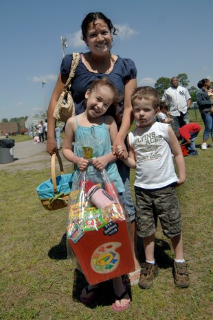 Haley Munton poses with mother, Deliah and brother, Michael, after receiving a prize for finding a special egg during the Easter egg hunt at Youth Programs April 11. An assorted Easter basket was given to the child who found the prize egg in each age group. Haley and Michael are the daughter and son of Deliah and Staff Sgt. David Munton. Sergeant Munton is a medical technician with the 437th Medical Group.