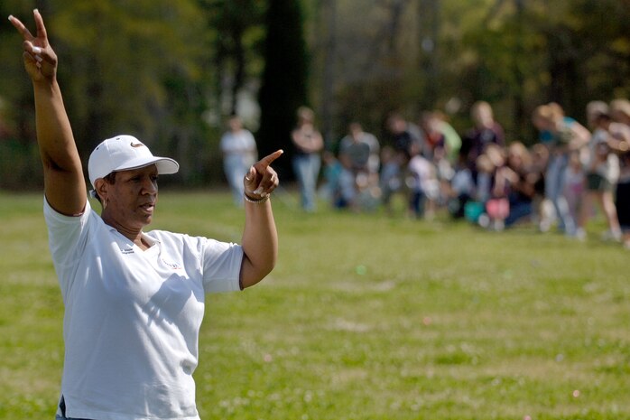 Jennifer Major counts down before parents let their children hunt for eggs on the soccer field at Youth Programs April 11. More than 400 children from age 1-to-12 made an appearance at the Easter egg hunt. Ms. Major is the program coordinator for the Charleston AFB youth center. (U.S. Air Force photo/Senior Airman Timothy Taylor)