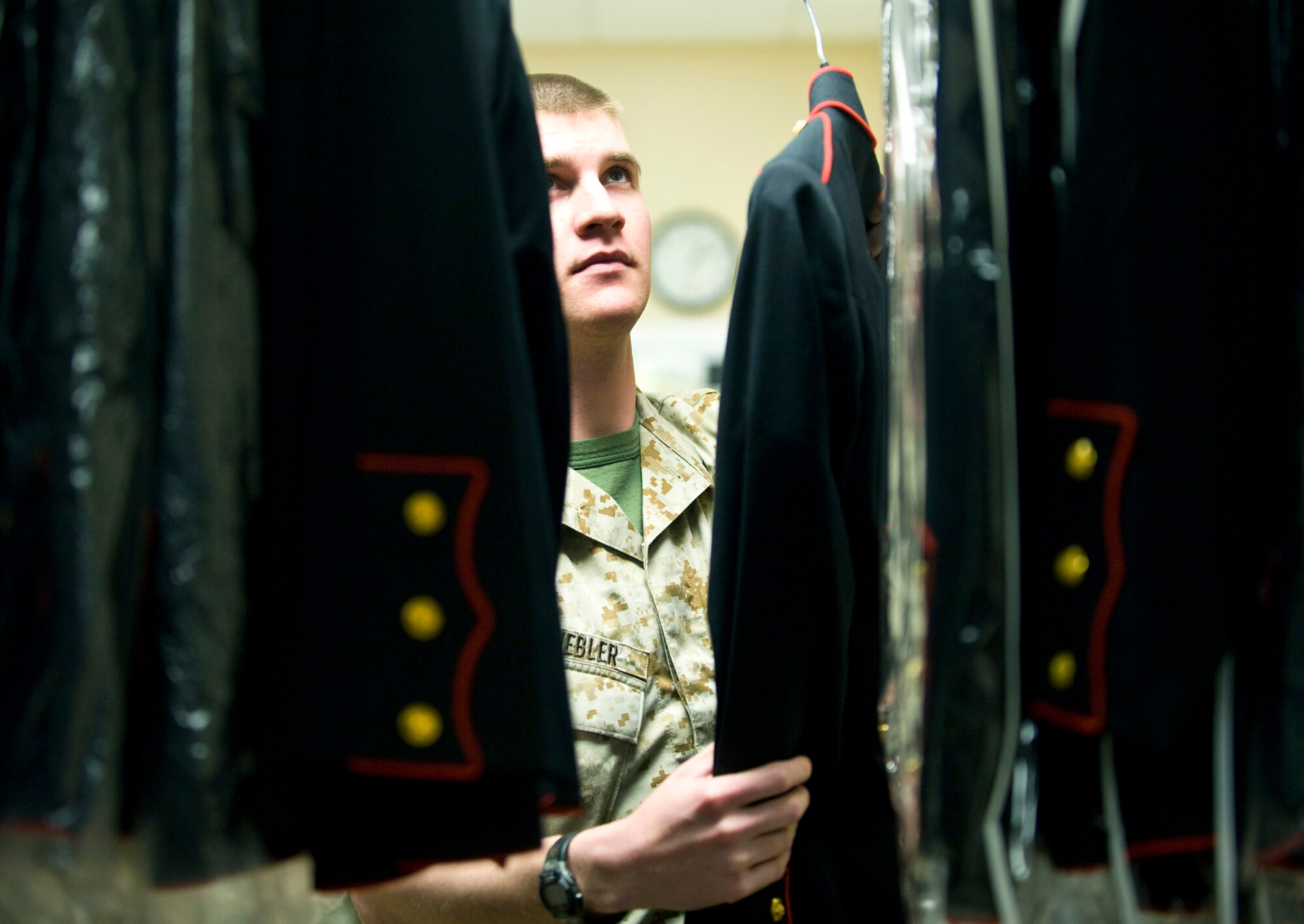 U.S. Marine Lance Corporal Adam Knebler, Marine liaison for uniforms section, hangs Marine service dress uniforms into inventory. The uniform section of the Charles C. Carson Center for Mortuary Affairs, Dover Air Force Base, Del., prepares uniforms for remains and works with military escorts for the dignified transfer of remains process. 
(U.S. Air Force photo by/Staff Sgt. Bennie J. Davis III)