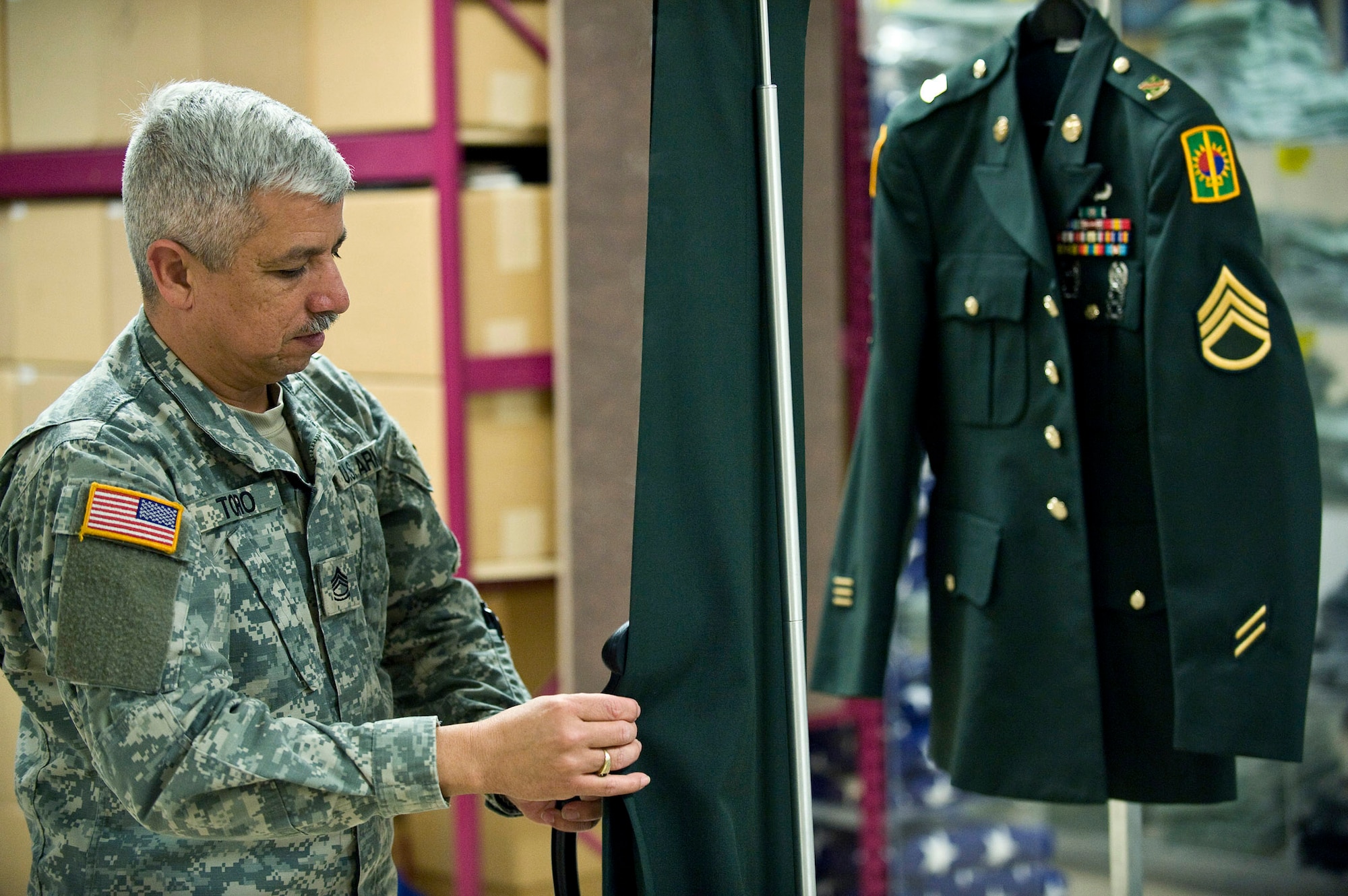 U.S. Army Sergeant First Class Jimmy Toro, a  mortuary affairs specialist, steam cleans the uniform of a fallen solider during preparation of the dignified transfer of remains process March 31. Sgt. Toro is on his third year-long voluntary deployment assisting the Air Force Mortuary Affairs Operations Center at Dover Air Force Base, Del. The servicemembers in the uniform section prepare uniforms for the fallen heroes and work with military escorts for the dignified-transfer-of-remains process.  Sergeant Toro is deployed from the U.S. Army Reserve, 311th Quartermaster Company in Puerto Rico. (U.S. Air Force photo/Staff Sgt. Bennie J. Davis III)