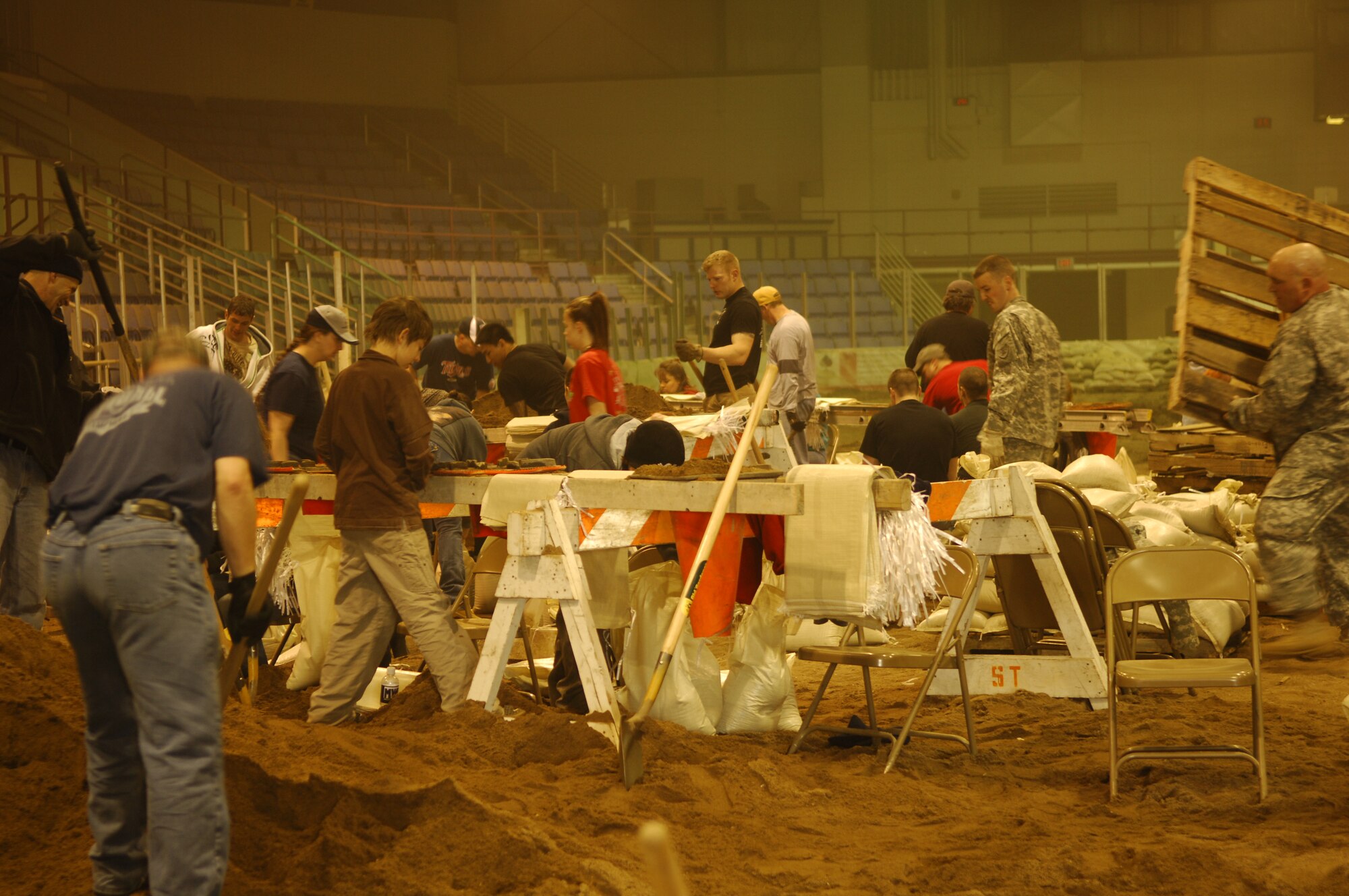 MINOT, N.D. – A flurry of activity ensues while volunteers from Minot Air Force Base and surrounding communities, as well as Soldiers from the Army National Guard, fill sandbags inside the All Seasons Arena here April 10. The group of volunteers was filling sandbags in preparation of flood relief efforts. (U.S. Air Force photo by Staff Sgt. Thomas Dow)