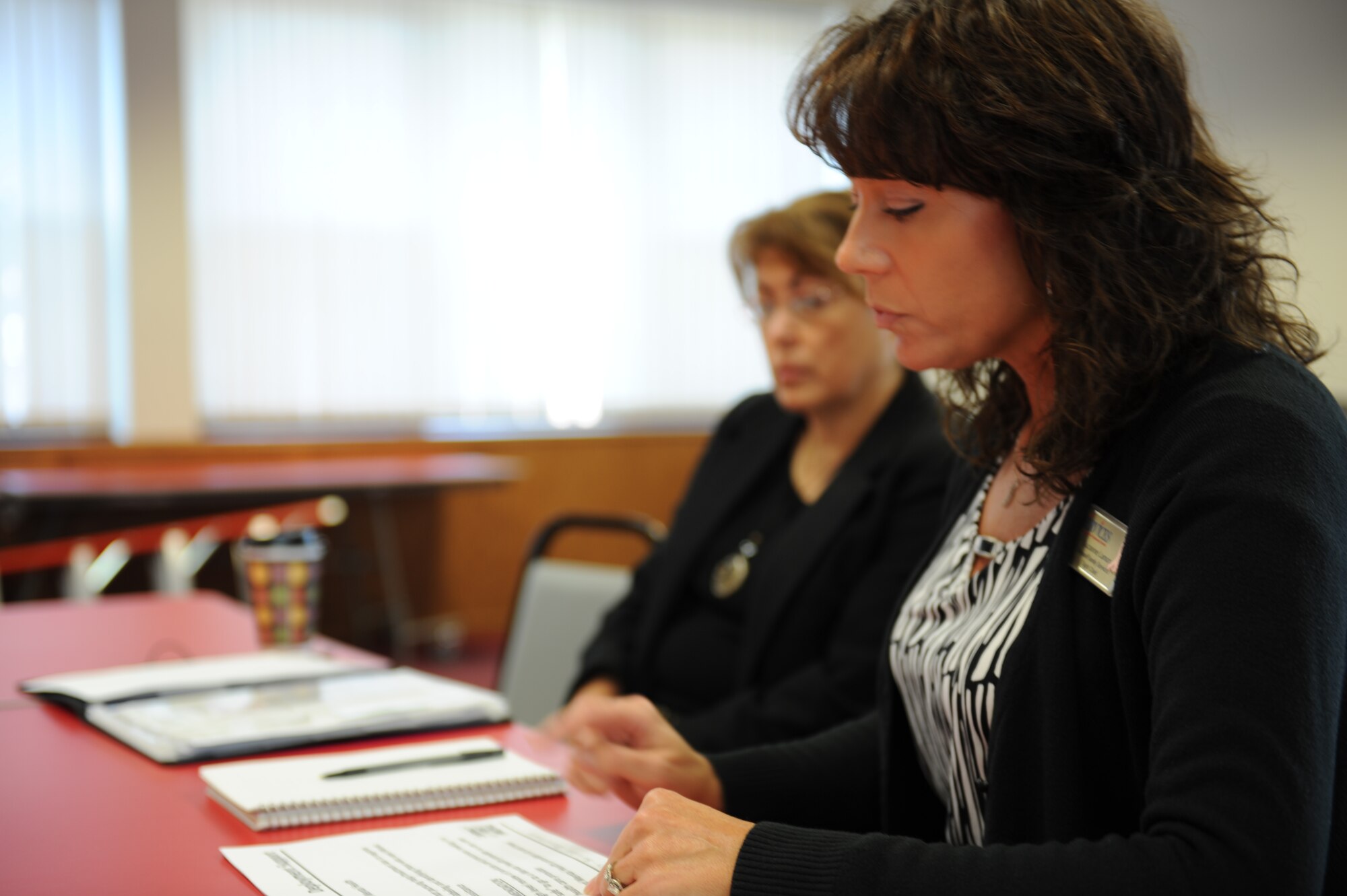 MINOT AIR FORCE BASE, N.D. -- Suzanne Larson, Airman and Family Services chair, shares information from a recent conference. Larson and Chaplain Weston Walker of the 5th Bomb Wing attended the “Caring for People Forum,” held in Washington D.C., March 31 to April 3. (U.S. Air Force photo by 2nd Lt. Kidron B. Vestal)  