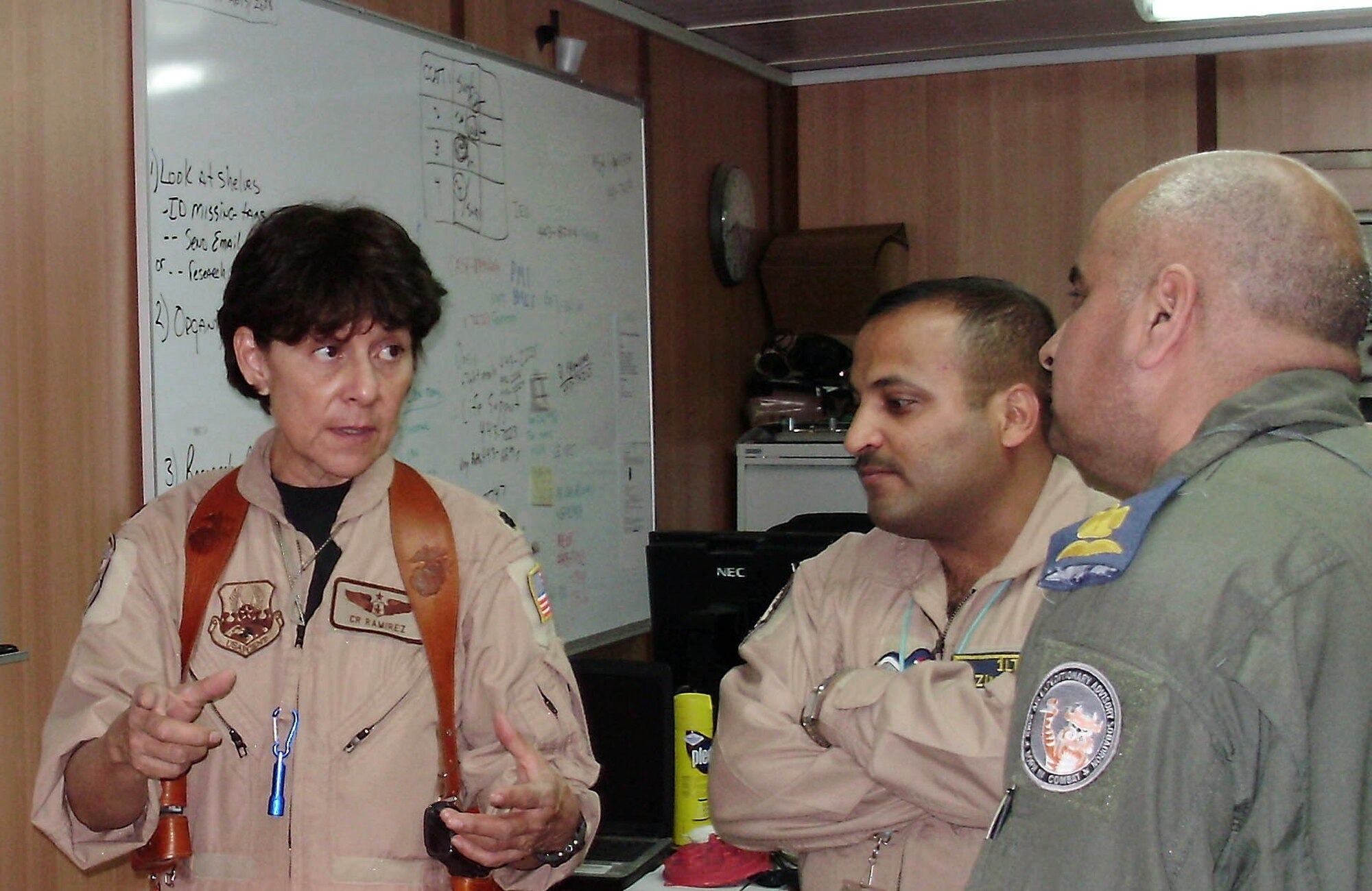 Lt. Col. C. R. Ramirez explains tracking the functioning status of aeromedical evacuation equipment to Iraqi air force flight surgeons Major (Dr.) Abdulrazzaq and Lt. (Dr.) Hazem March 11 at Joint Base Balad, Iraq. Colonel Ramirez is assigned to the 332th Expeditionary Operation Support Squadron deployed from Travis Air Force Base, Calif. (Courtesy photo) 
