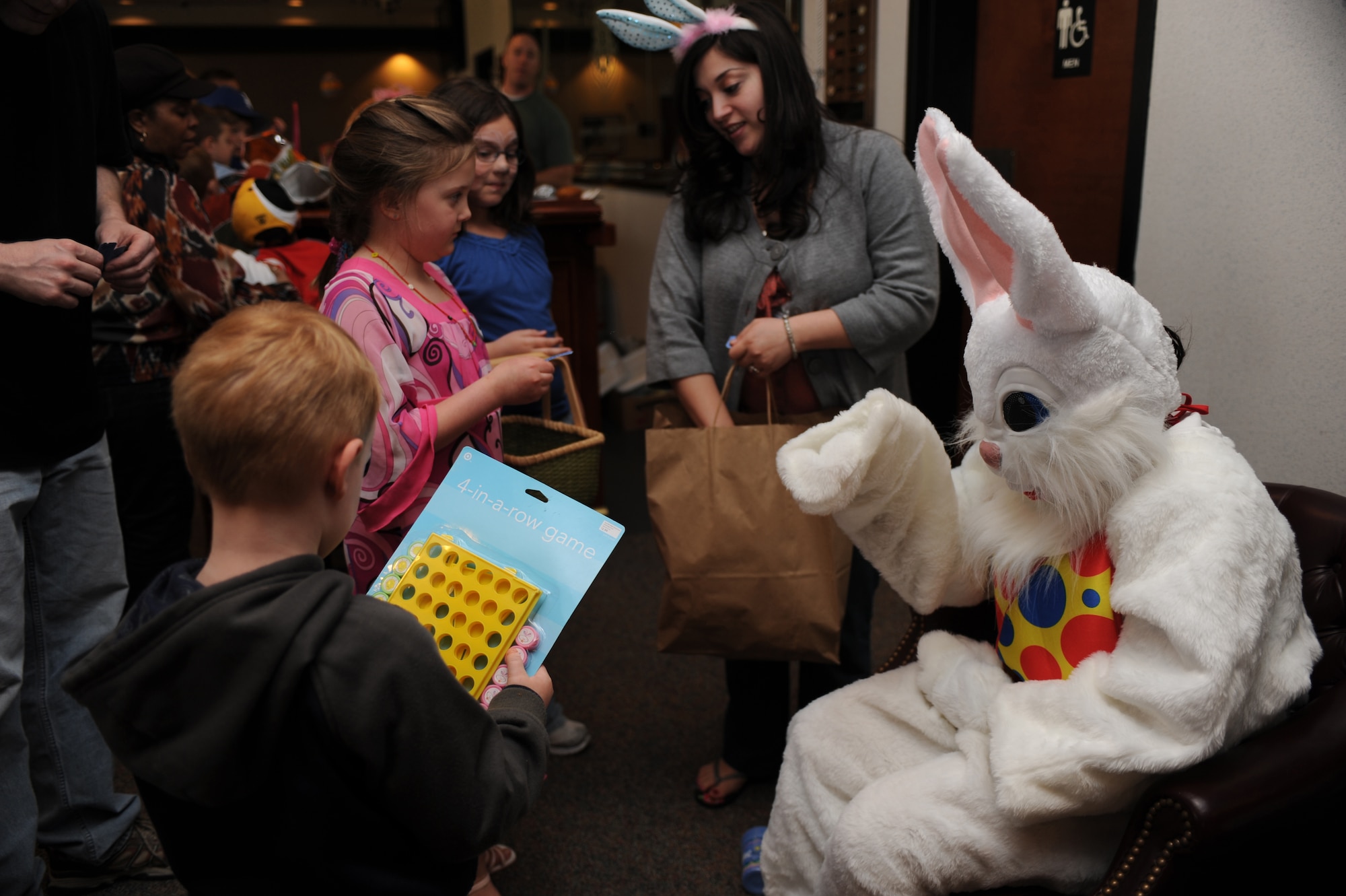The Easter bunny hands out gifts and prizes to children during a Easter party at the Expeditionary Center on Fort Dix, N.J., April 4, 2009.  The Easter party consisted of arts and crafts, a photo session with the Easter bunny and an Easter egg hunt.   (U.S. Air Force Photo/Staff Sgt. Nathan G. Bevier) 