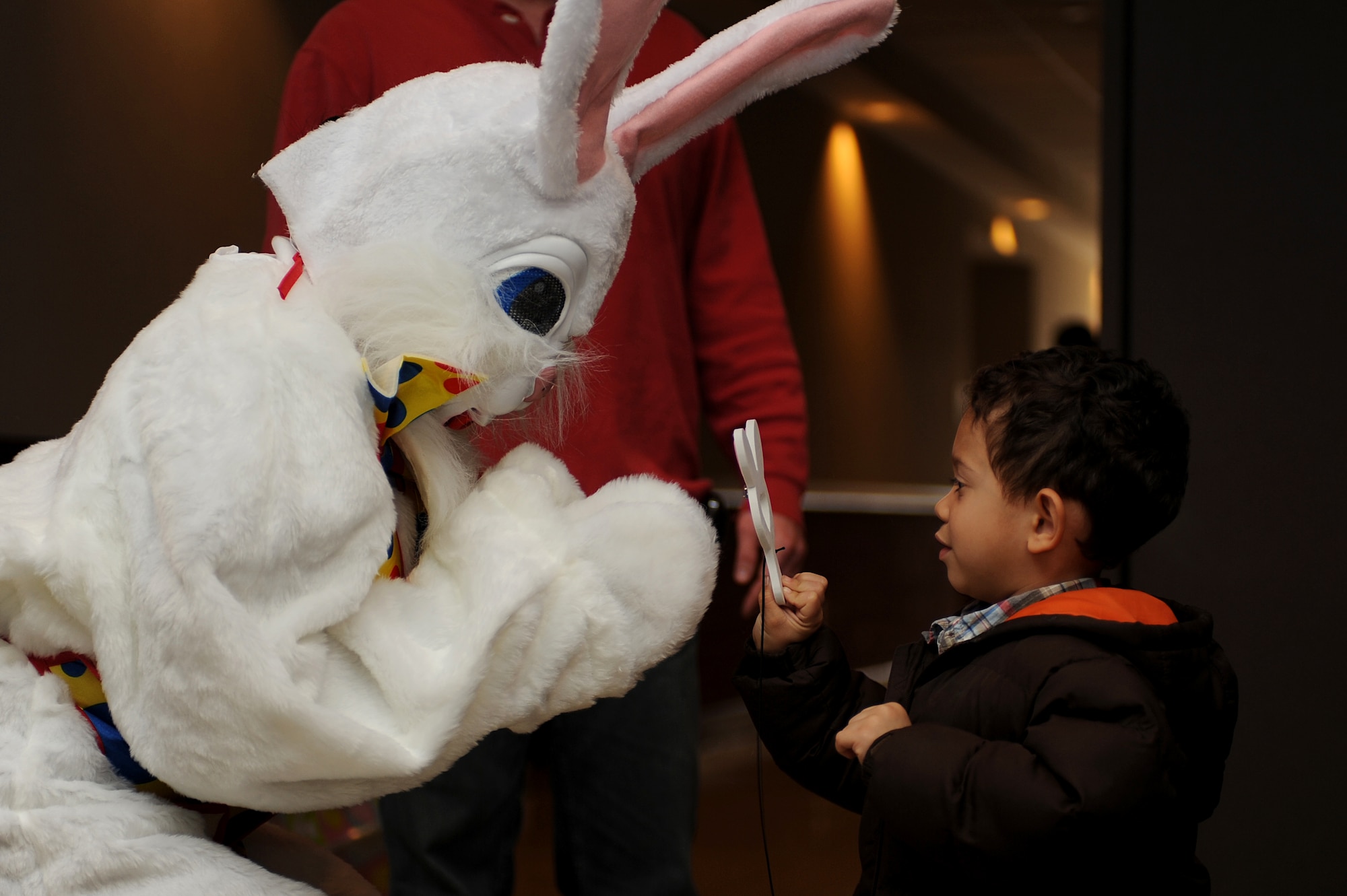 Darien McDavid, 3 year old son of Staff Sgt. Veuril and Tracy McDavid, shows the Easter bunny his paddle ball he made at arts and crafts during a Easter party at the Expeditionary Center on Fort Dix, N.J., April 4, 2009.  The Easter party consisted of arts and crafts, a photo session with the Easter bunny and an Easter egg hunt.   (U.S. Air Force Photo/Staff Sgt. Nathan G. Bevier) 