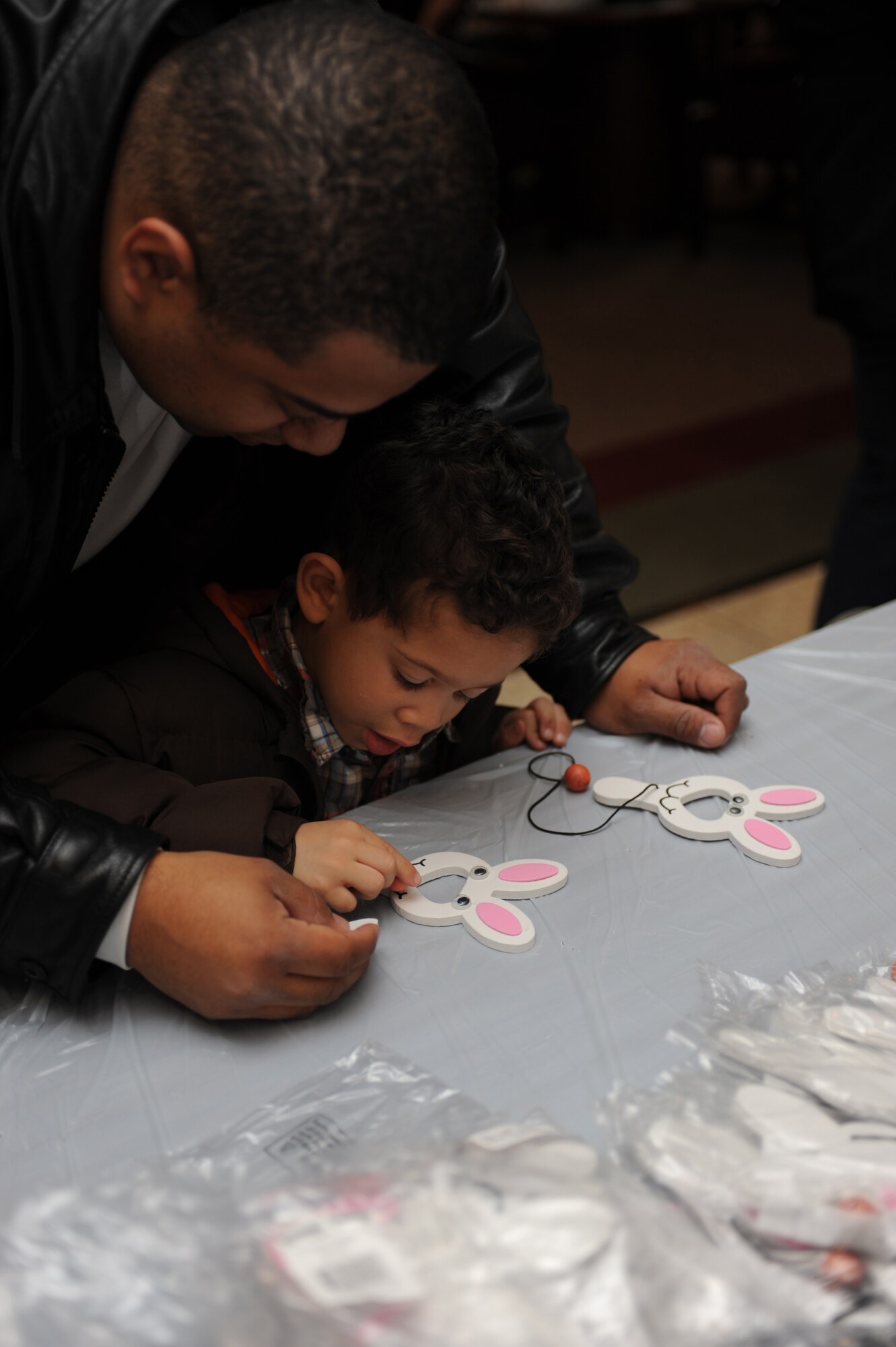 Staff Sgt. Veuril McDavid and his 3 year old son, Darien McDavid, make an Easter paddle ball for arts and crafts during a Easter party at the Expeditionary Center on Fort Dix, N.J., April 4, 2009.  The Easter party consisted of arts and crafts, a photo session with the Easter bunny and an Easter egg hunt.   (U.S. Air Force Photo/Staff Sgt. Nathan G. Bevier) 