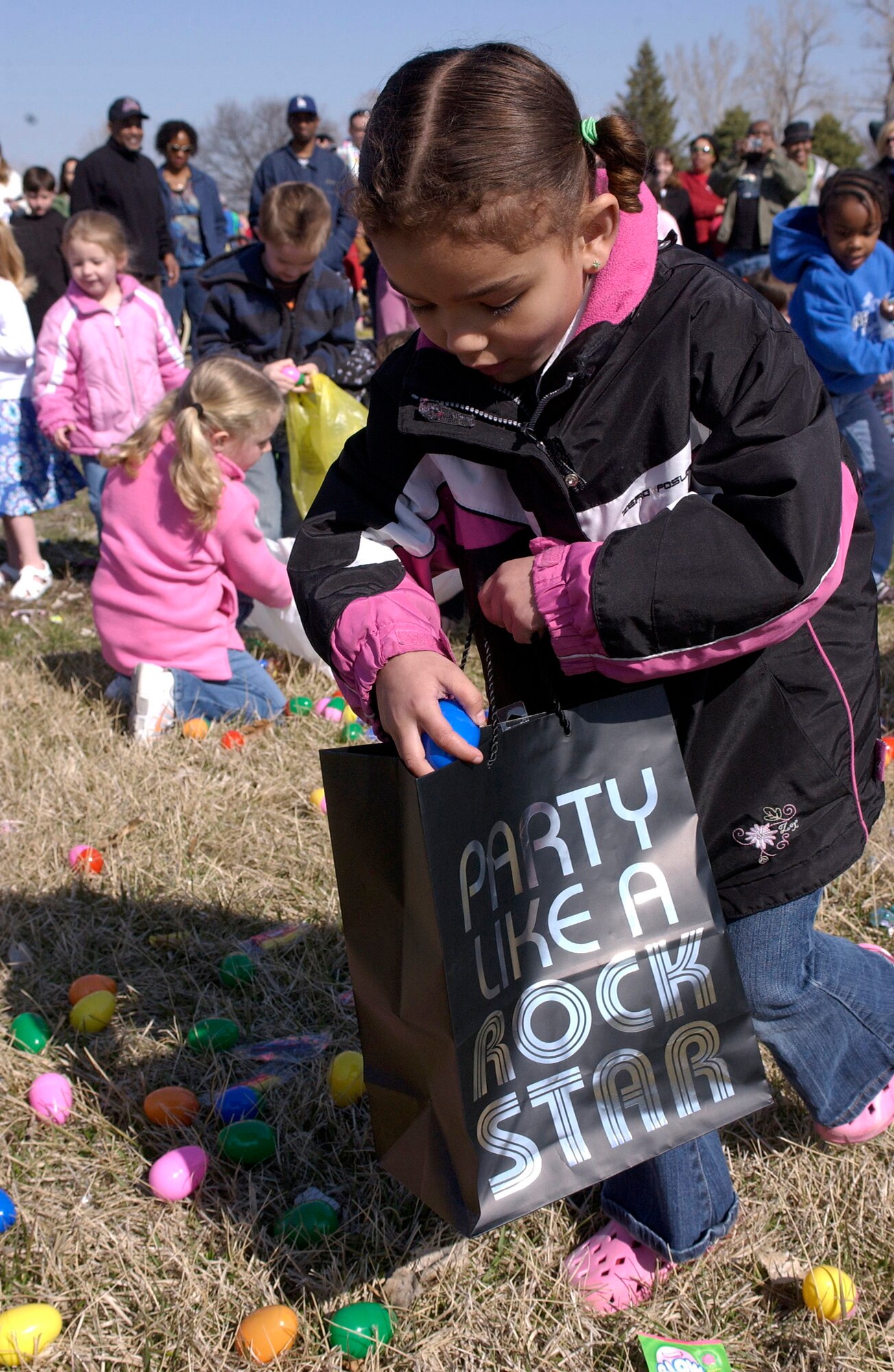 OFFUTT AIR FORCE BASE, Neb. -- Ms. Olivia Hart fills her bag with a bounty of eggs during Offutt's annual Easter Egg Scramble at the base lake April 11. Hart, participating in the 4-6 year old category, was one of more than 500 participants in the event hosted by the 55th Force Support Squadron Youth Center.  U.S. Air Force Photo By: Staff Sgt. Richard Williams