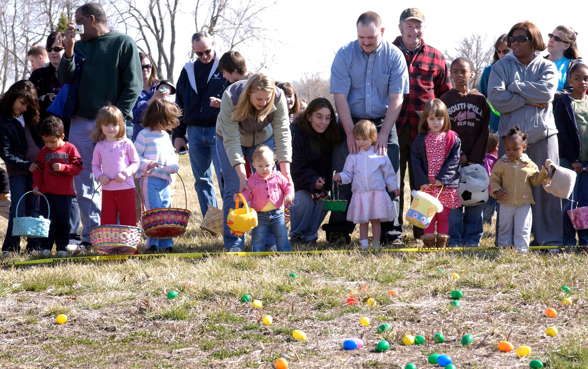 OFFUTT AIR FORCE BASE, Neb. -- Children in the 1-3 year old group get ready to collect their eggs during Offutt's annual Easter Egg Scramble at the base lake April 11. The event saw over 500 participants and cheerleaders in five different age groups gather toy eggs and all the candy they could grab.  U.S. Air Force Photo By: Staff Sgt. Richard Williams
