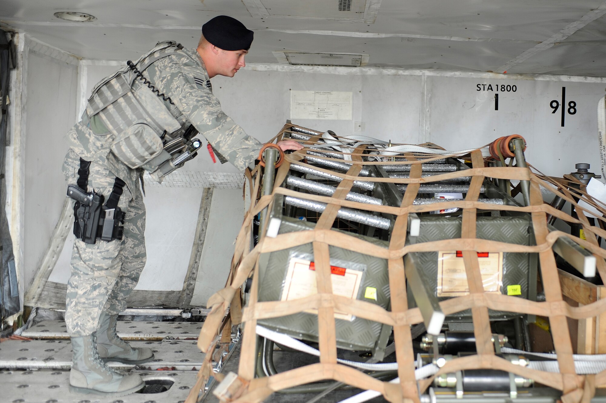 Senior Airman Adam Klockziem inspects French Air Force cargo April 13, 2009, Eielson Air Force Base Alaska. Security forces Airmen ensure all equipment removed from the aircraft matches the manifest information. Airmen Klockziem is assigned to the 354th Security Forces Squadron.  (U.S. Air Force photo/Senior Airman Jonathan Snyder)