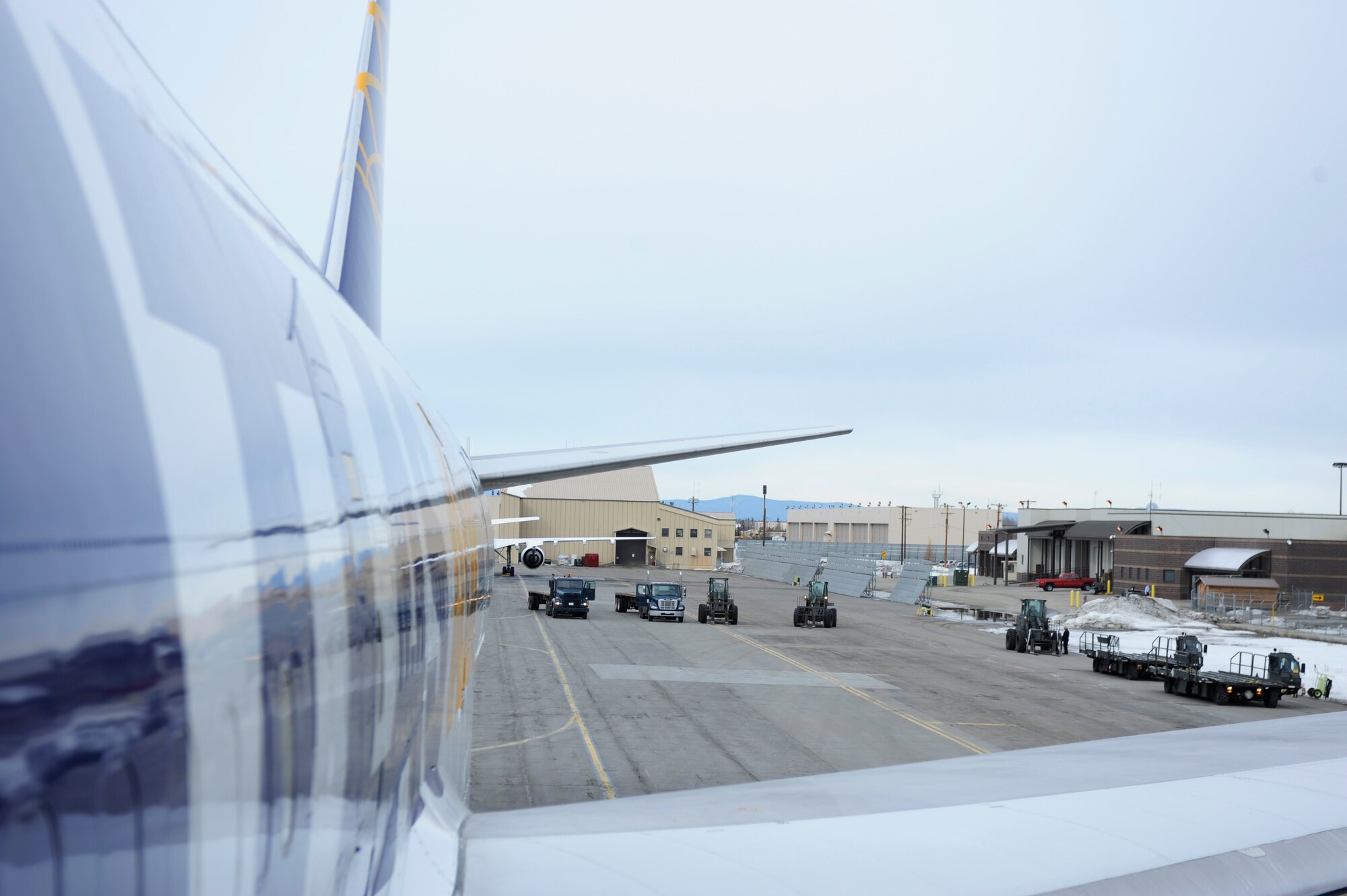 A Boeing 747 carrying French Air Force cargo sits on the tarmac while a fleet of transport vehicles wait to unload the cargo, April 13, 2009, Eielson Air Force Base Alaska. The French Arm?e de l'Air will be participating in the upcoming RED FLAG-Alaska 09-2.  (U.S. Air Force photo/Senior Airman Jonathan Snyder)