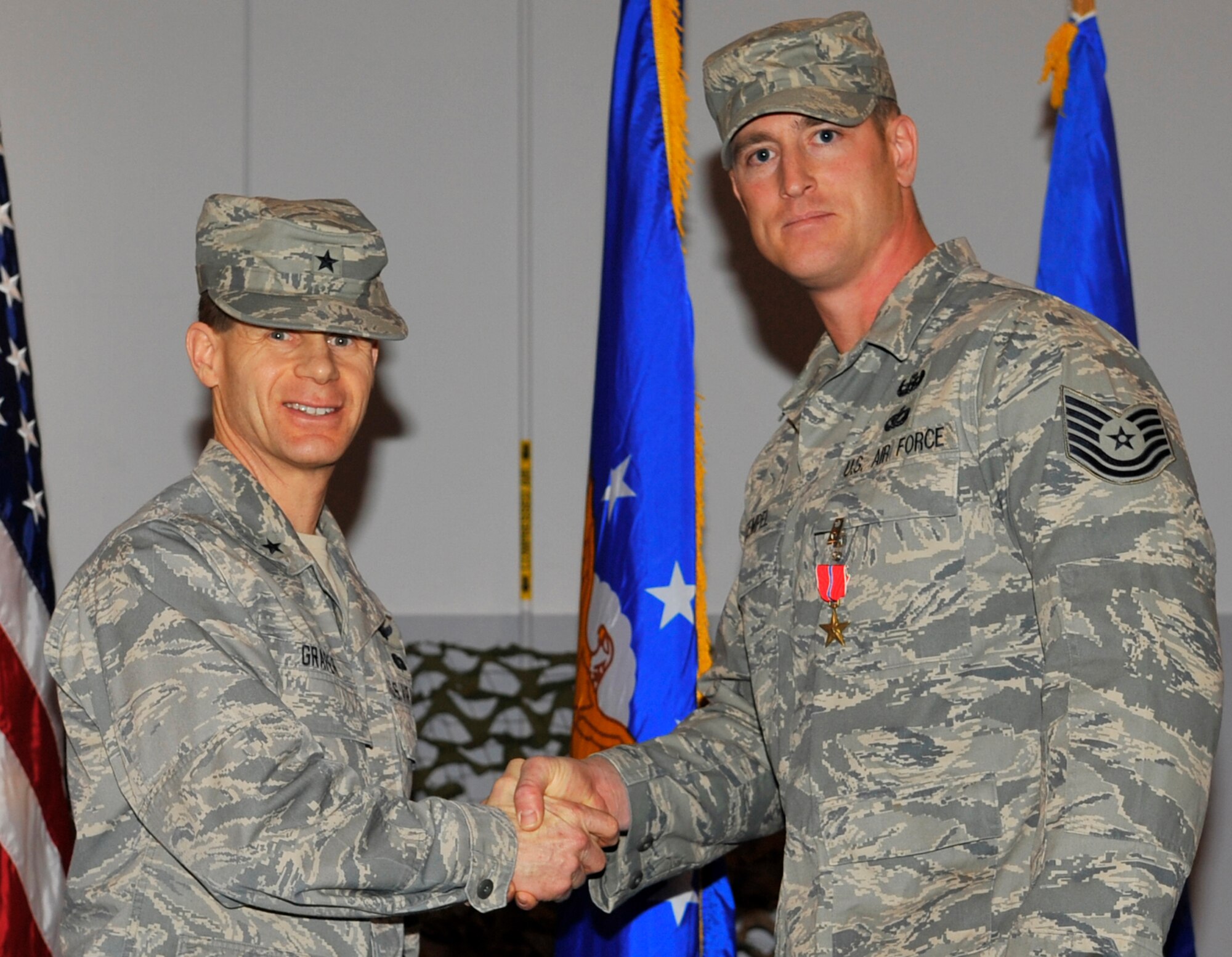 EIELSON AIR FORCE BASE, ALASKA -- Tech Sgt. Heath Tempel shakes hands with Brig. Gen. Mark W. Graper after receiving the Bronze Star here during a welcome home ceremony Apr. 10. Sergeant Tempel was awarded the Bronze Star for his outstanding leadership in Operation Iraqi Freedom. (U.S. Air Force photo/Senior Airman Christopher Boitz)