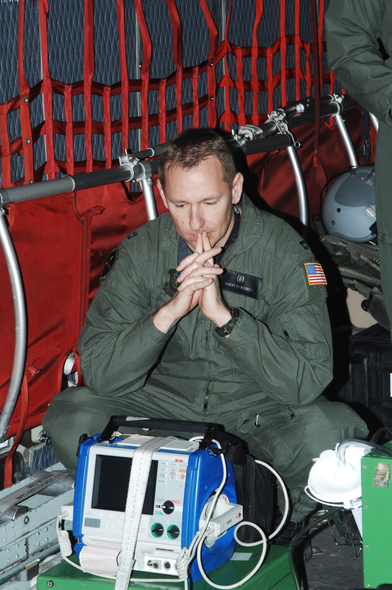 CANNON AIR FORCE BASE, N.M. -- Capt. Robert Niewoonder, 27th Special Operations Support Squadron Medical Operations Flight, looks at some of the medical equipment used by the flight during an in-flight medical situation. The flight hosted a familiarization event to get to know the unit for senior medical administrators from Clovis and Portales, N.M. hospitals April 1. (U.S. Air Force photo/Greg Allen)  