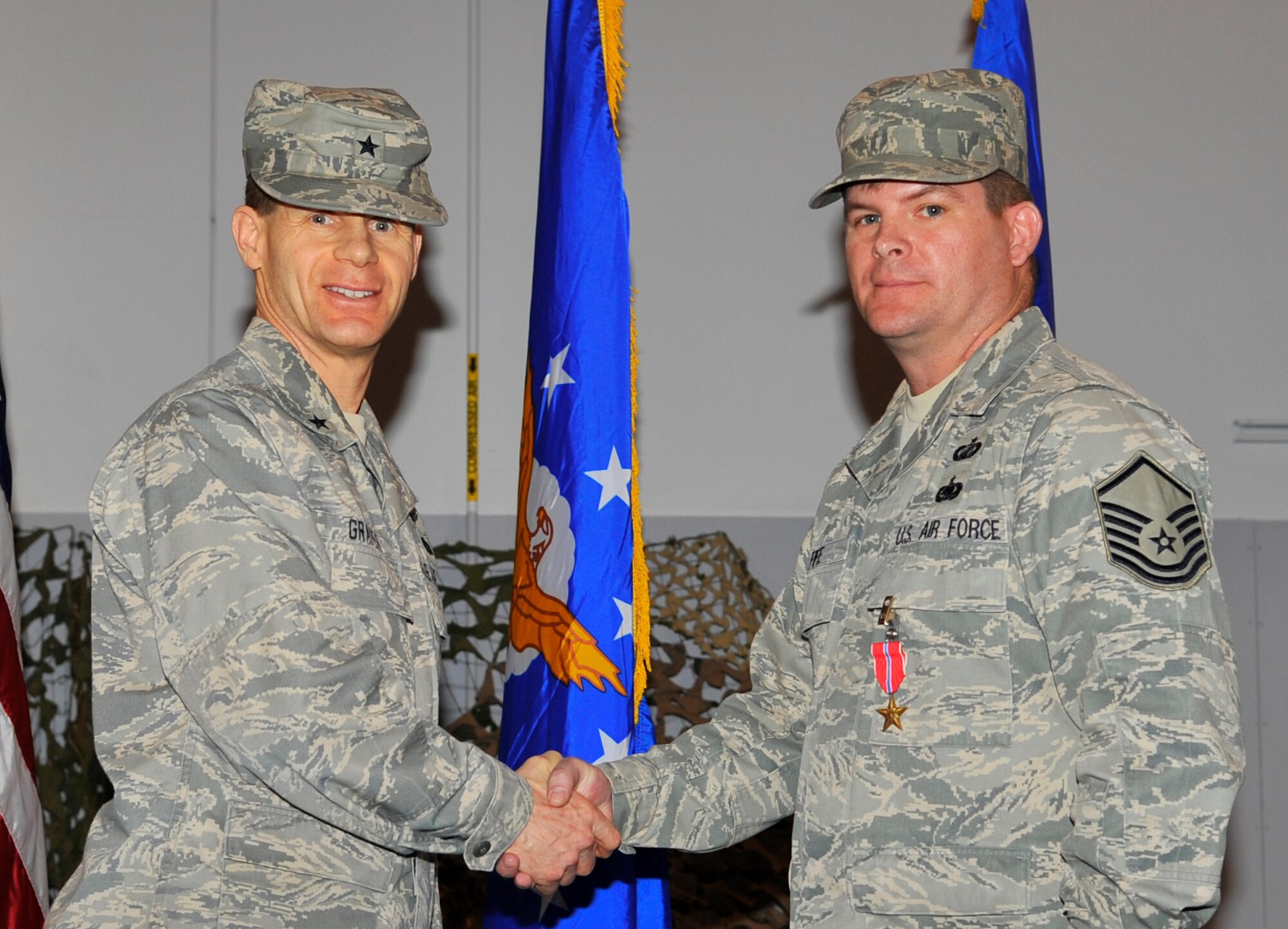 EIELSON AIR FORCE BASE, ALASKA -- Master Sgt. John Fife shakes hands with Brig. Gen. Mark Graper after receiving the Bronze Star here during a welcome home ceremony Apr. 10. Sgt. Fife was awarded the Bronze Star for his outstanding leadership in Operation Iraqi Freedom. (U.S. Air Force photo/Senior Airman Christopher Boitz)