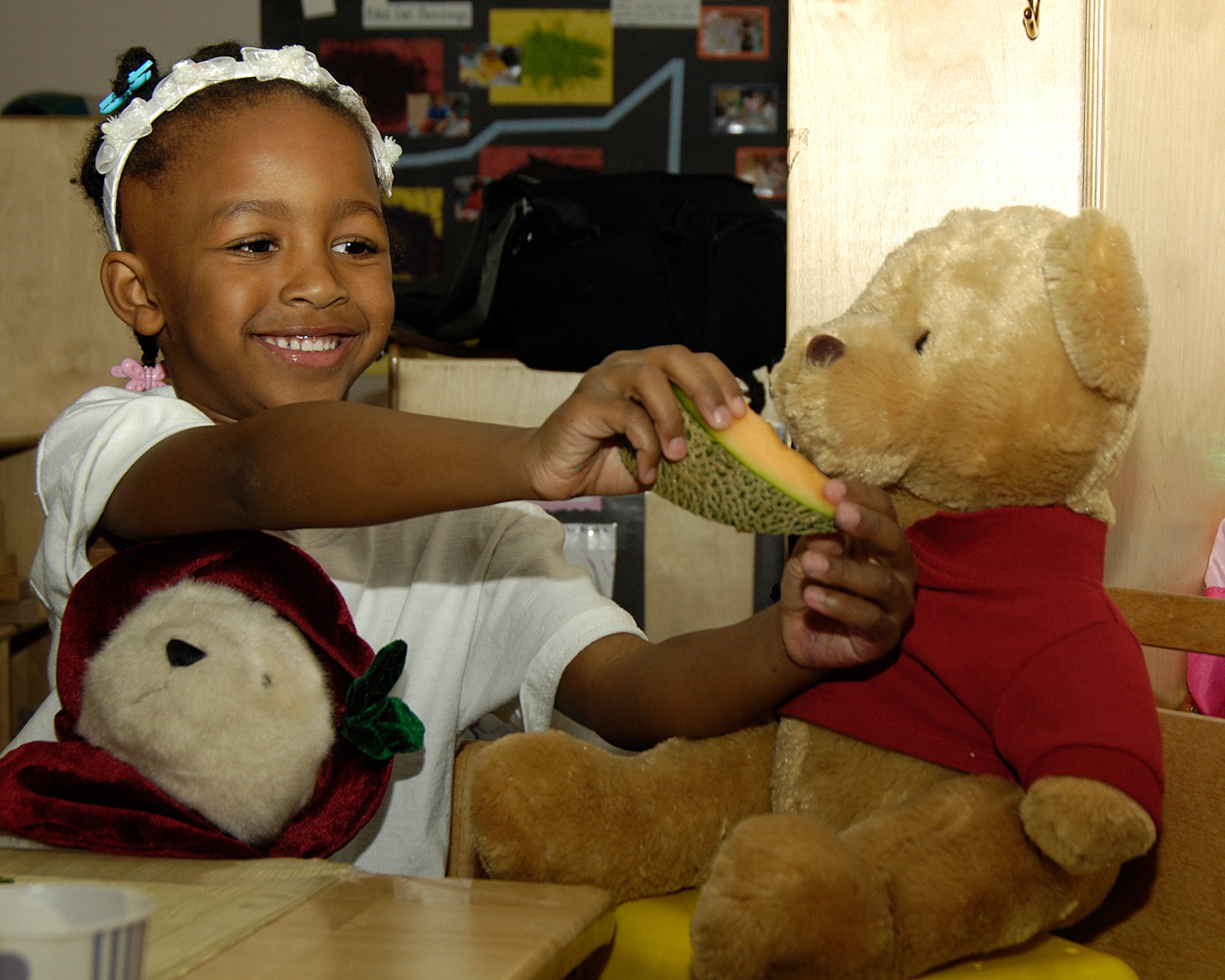 HANSCOM AIR FORCE BASE, Mass. - Madison Whitehurst shares some cantaloupe with her Teddy Bear during the Child Development Center’s Teddy Bear picnic on April 9. Hanscom is celebrating the Month of the Military Child with activities and events taking place to celebrate and honor the youngest members of the military community. (U.S. Air Force photo by Linda LaBonte Britt)