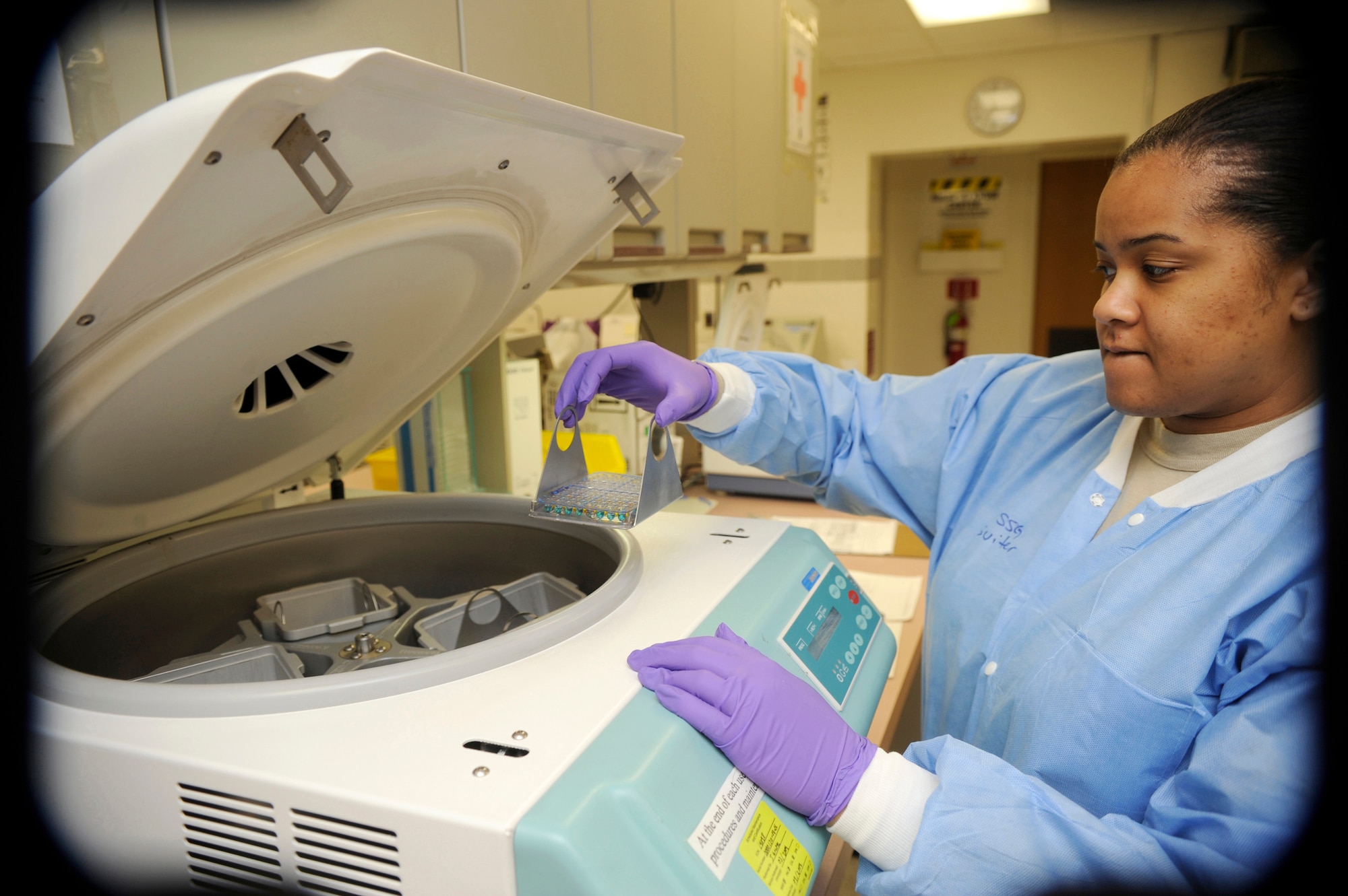 Army Reserve Staff Sgt. Shawntel Suiter, Armed Services Whole Blood Processing Laboratory/East lab technician, places testing trays filled with red blood cells and reagent into a centrifuge March 6. There are a total of 15 laboratory professionals at the ASWBPL at McGuire. This lab is a tri-service facility manned by personnel from the Army, Navy, and Air Force including active duty, Reserves, and civilians. (U.S. Air Force photo/Carlos Cintron)
